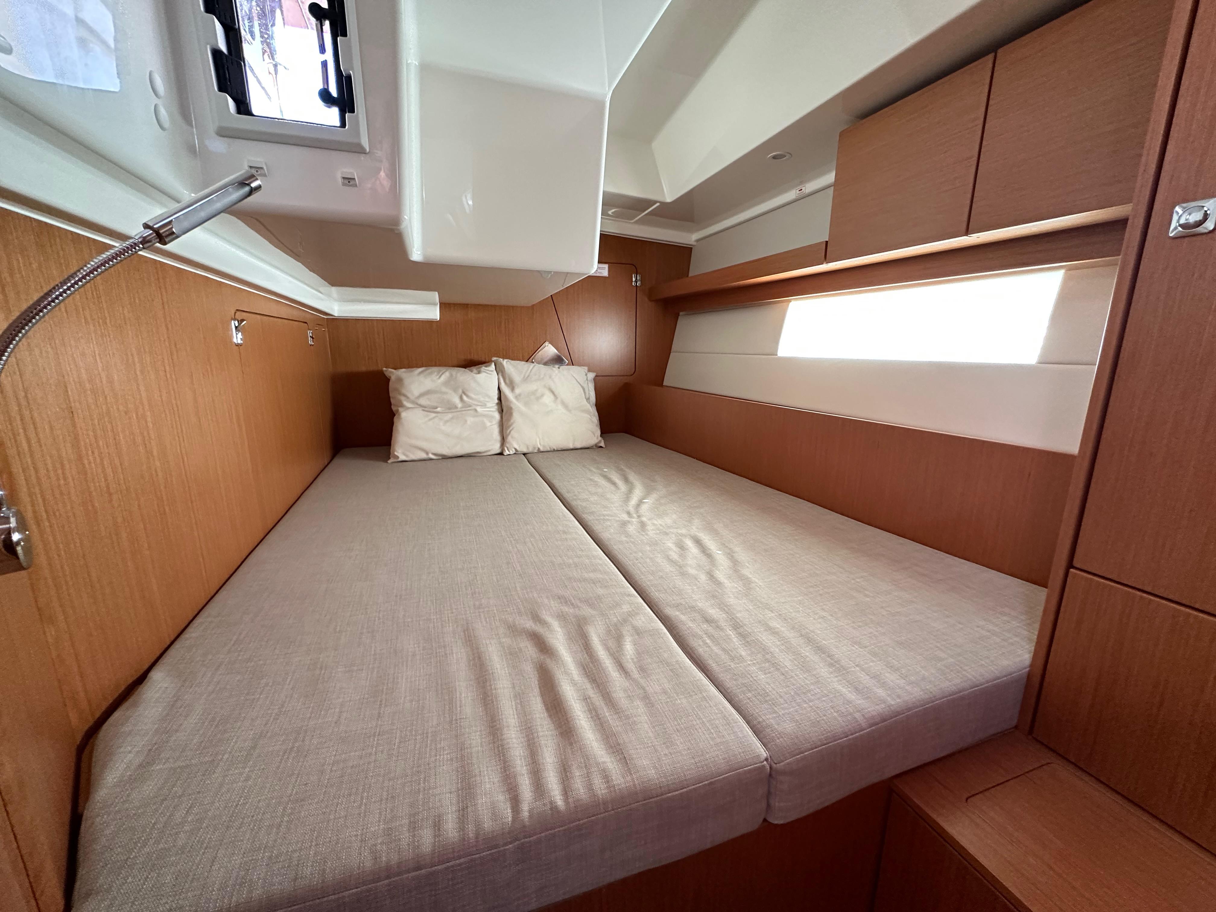 Bavaria-C45 2024-In stock and availabe now CA-US-2024 Bavaria C45 yacht cabin with cozy bed and modern wood finish.-9712200 | Thumbnail