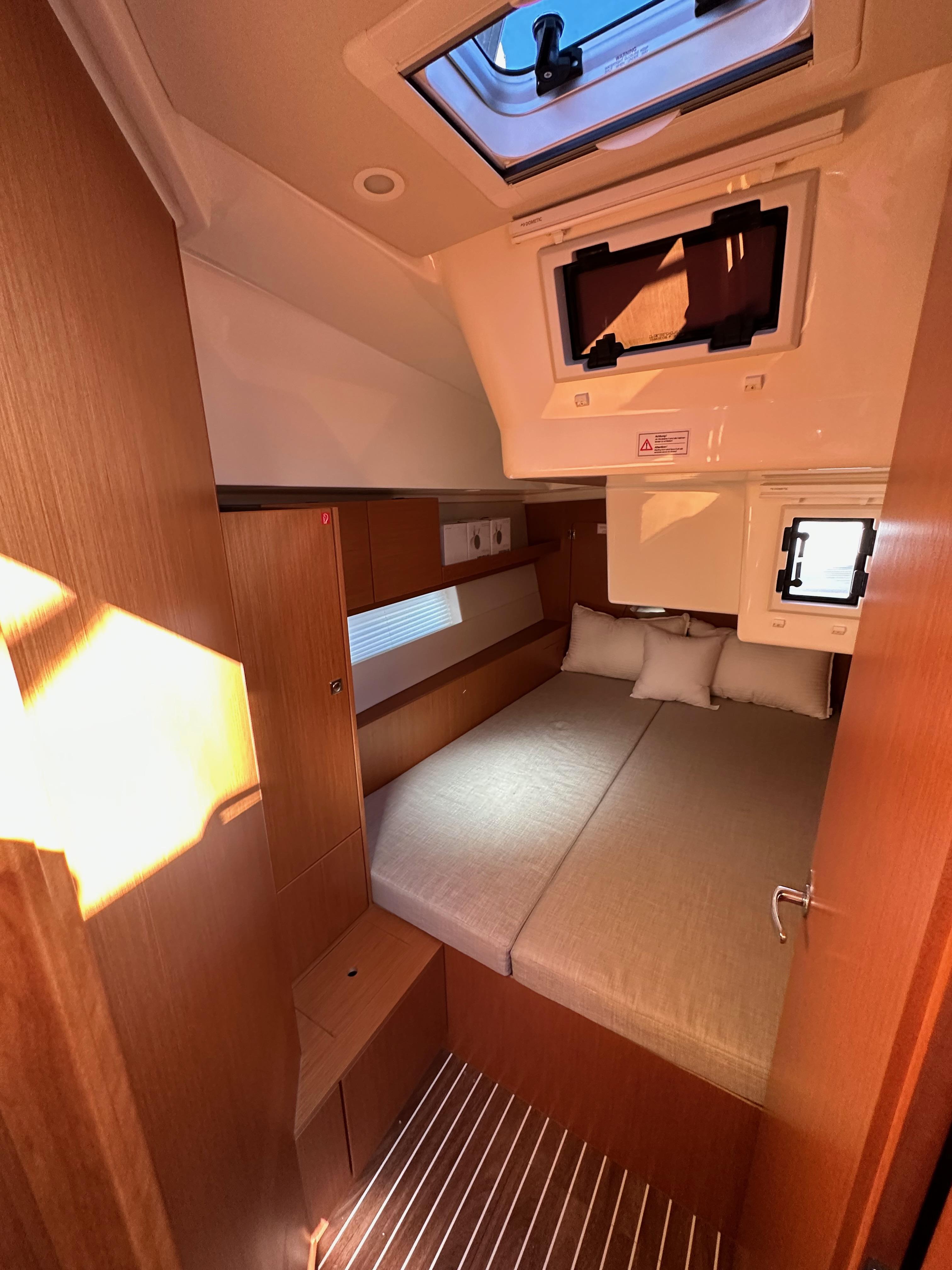 Bavaria-C45 2024-In stock and availabe now CA-US-2024 Bavaria C45 yacht cabin interior with bed, wooden finish, and skylight.-9712200 | Thumbnail