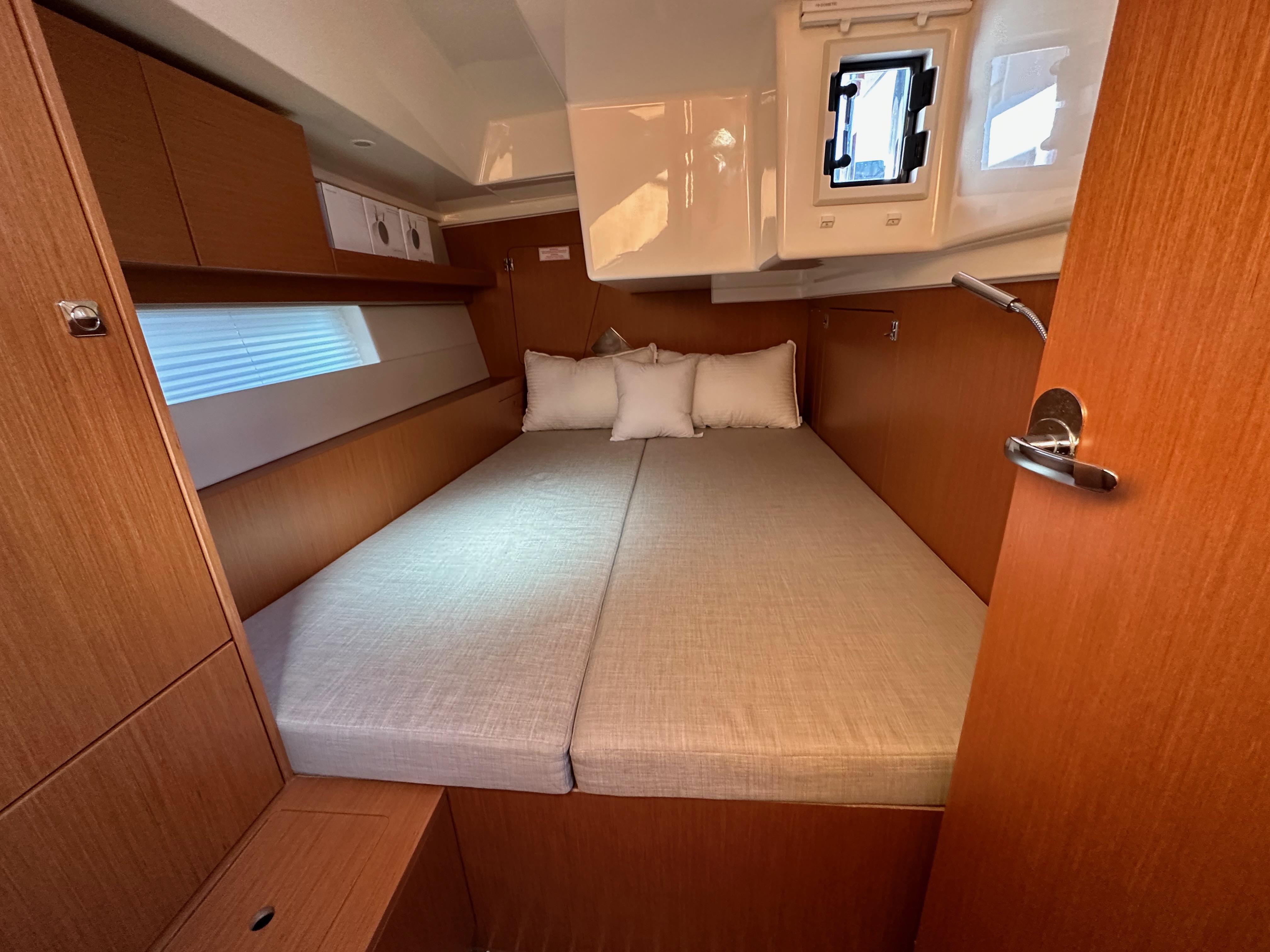 Bavaria-C45 2024-In stock and availabe now CA-US-2024 Bavaria C45 yacht cabin with cozy bed and wooden interior.-9712200 | Thumbnail
