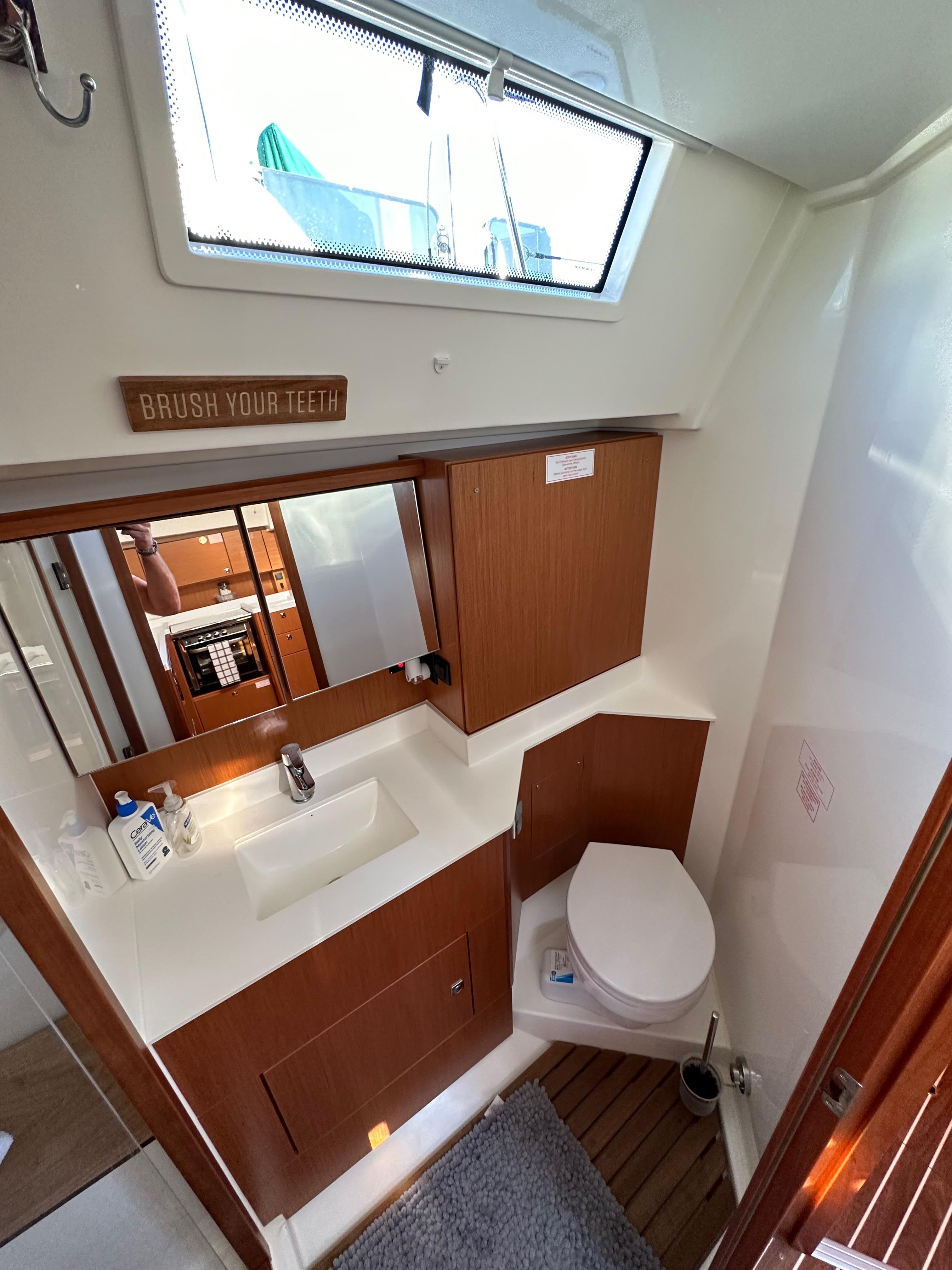 Bavaria-C45 2024-In stock and availabe now CA-US-2024 Bavaria C45 yacht bathroom with modern fixtures and wooden cabinetry.-9712200 | Thumbnail
