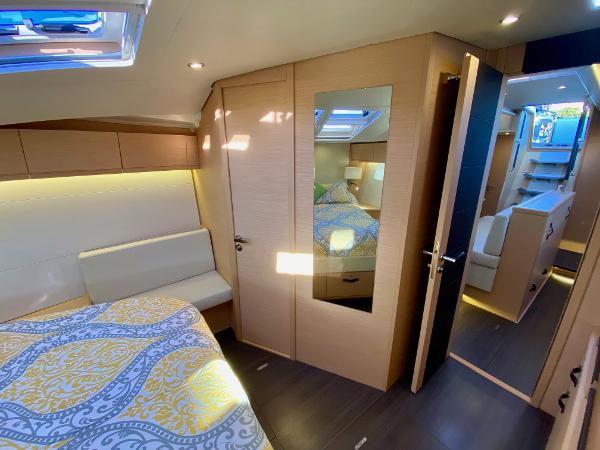 Luxurious interior of 2016 Jeanneau 54 yacht with modern design and cozy bedroom.