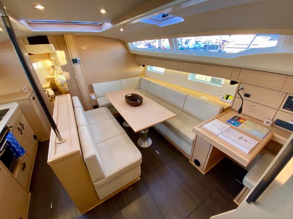 Luxurious interior of a 2016 Jeanneau 54 yacht with elegant seating and dining area.