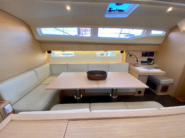 Interior of 2016 Jeanneau 54 yacht with modern seating and dining area.
