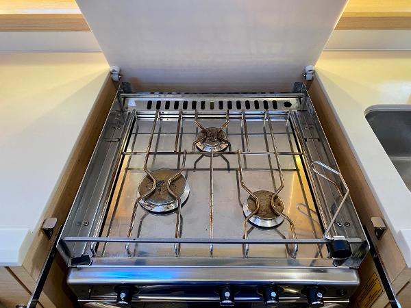 Stainless steel stove with three burners on a 2016 Jeanneau 54 yacht.