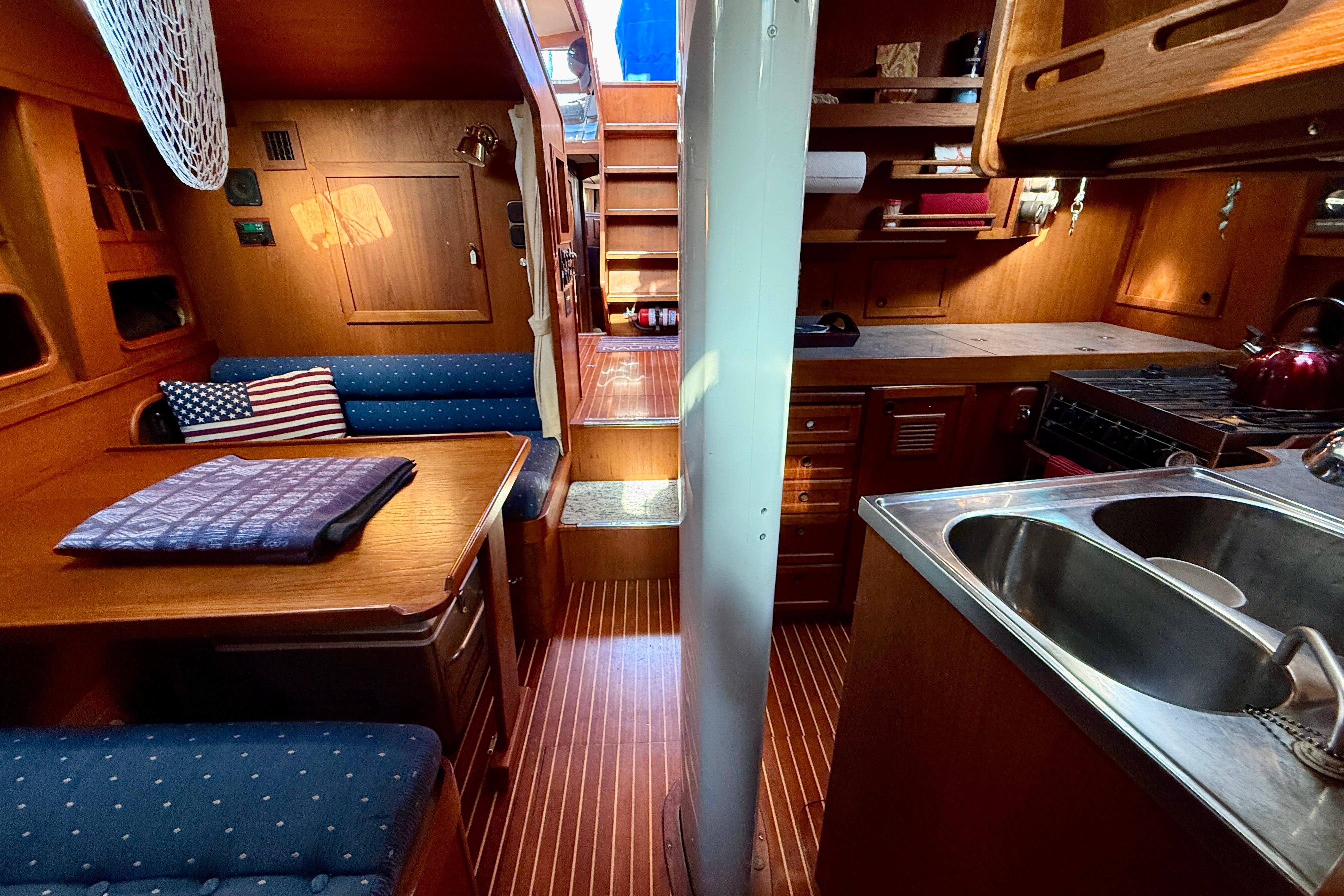 Galley to port with dinette to starboard a few steps down from pilothouse