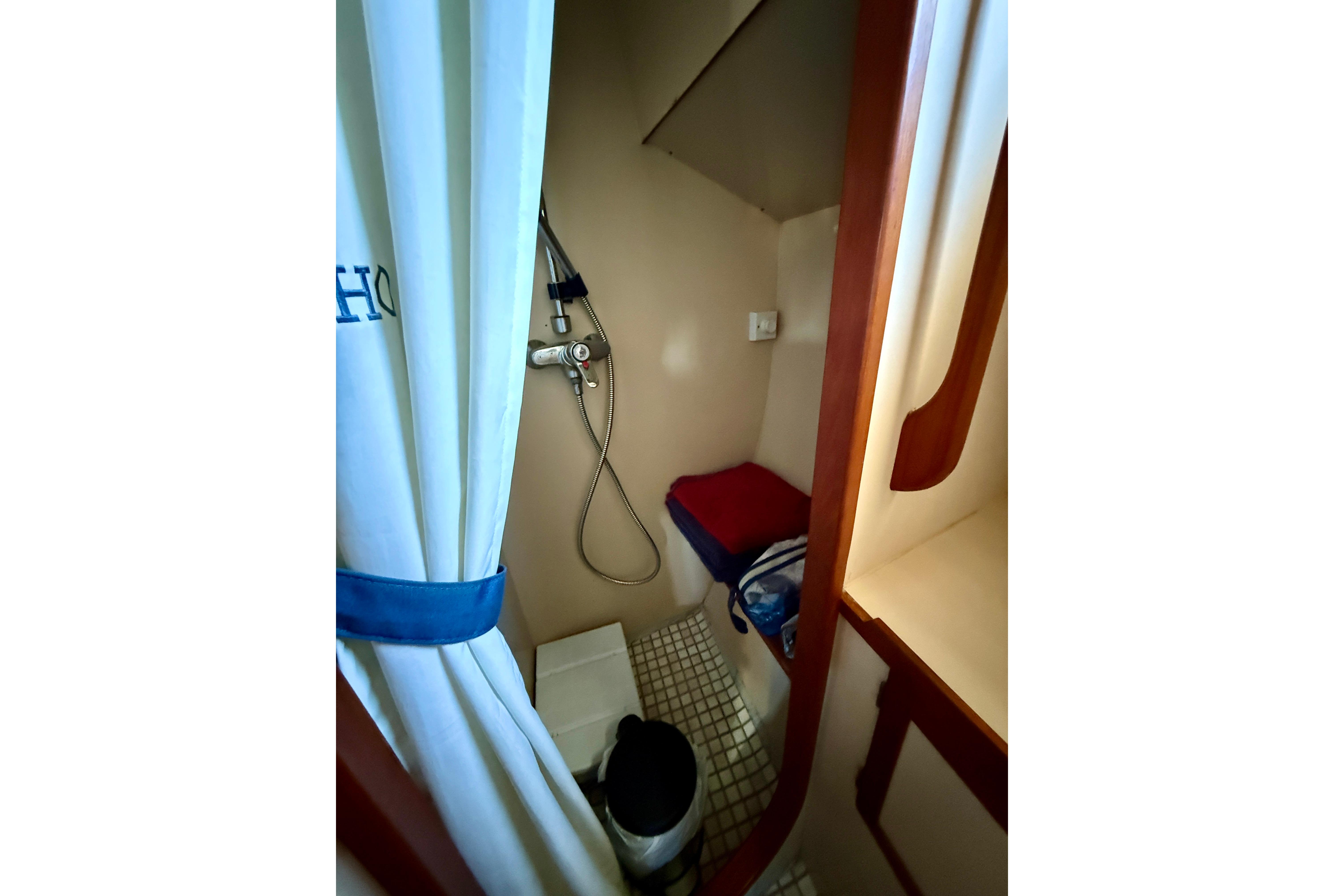Stall shower with seat and curtain.