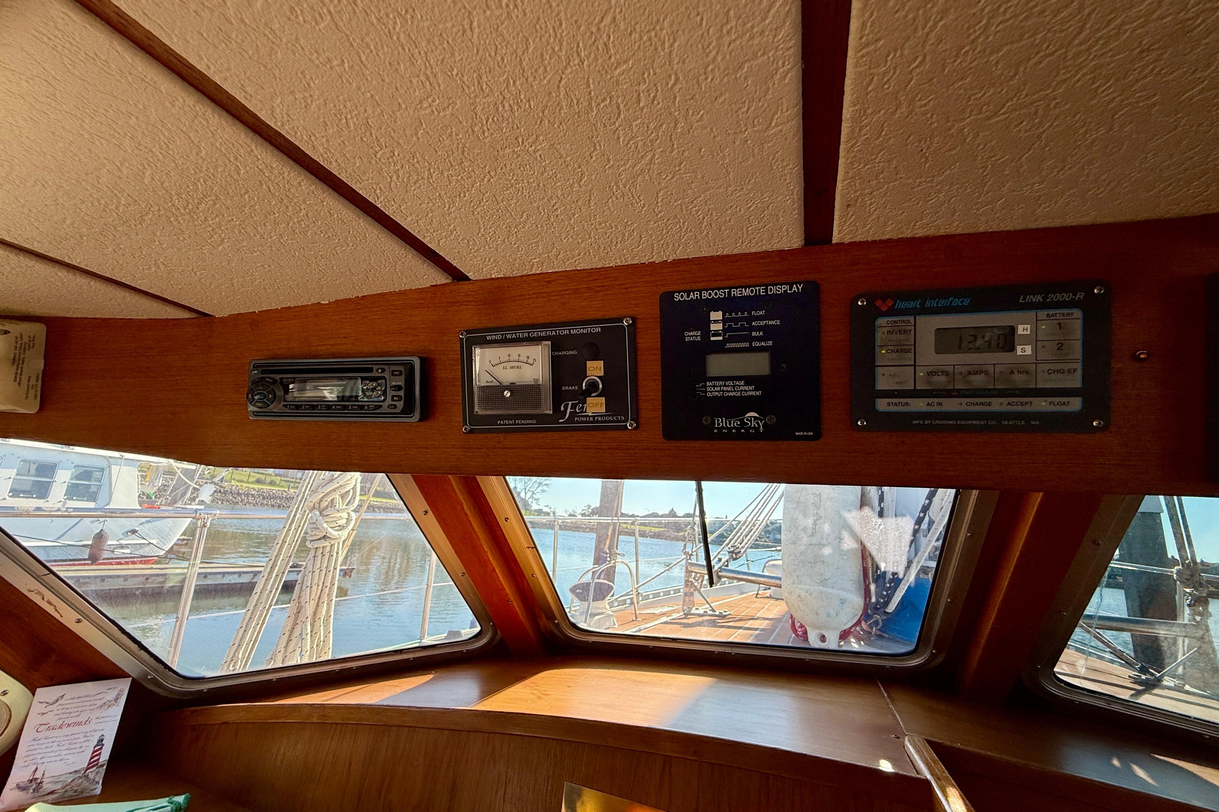 Interior of 1986 Nauticat 43 sailboat with control panels and marina view.