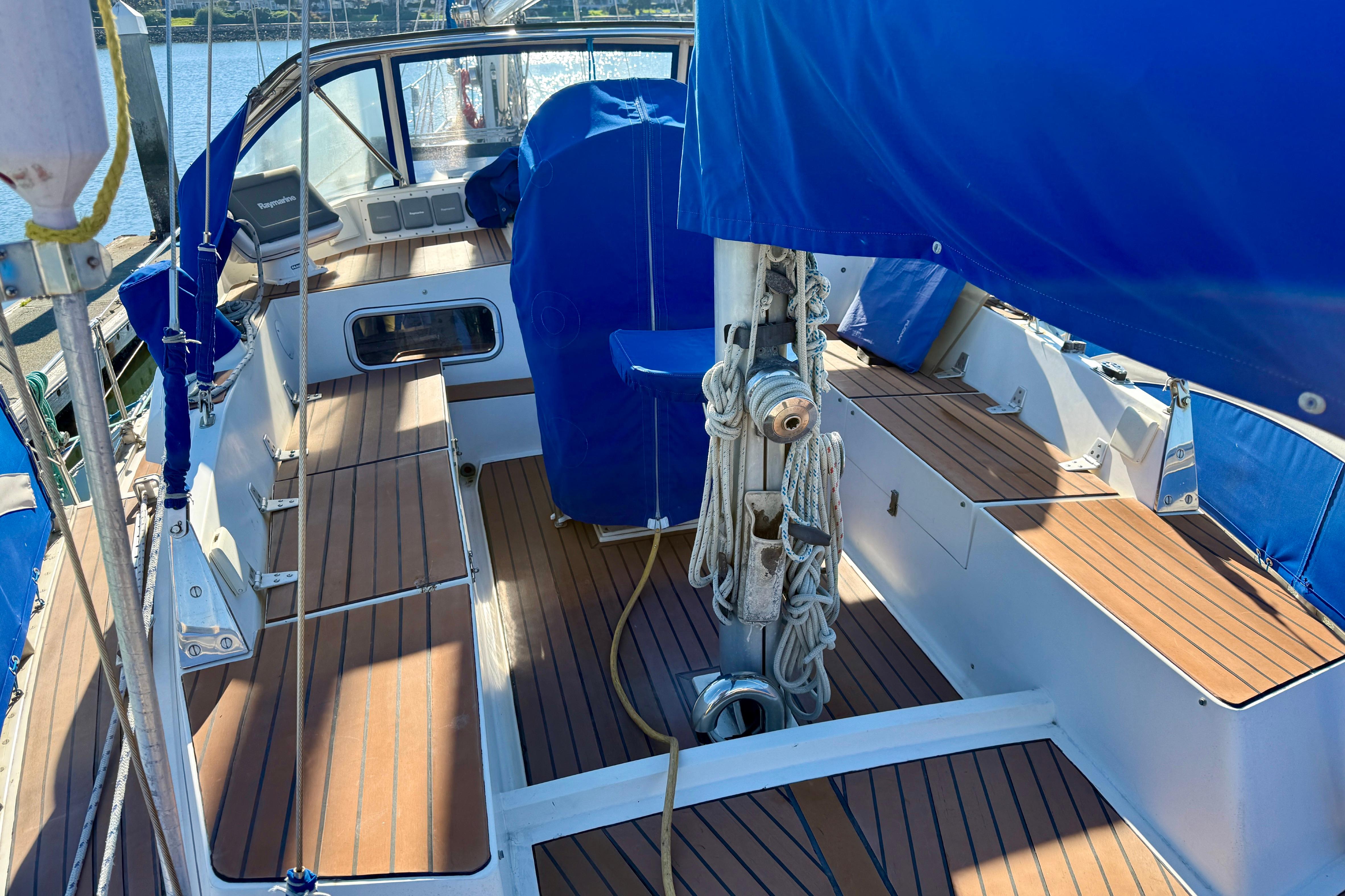 1986 Nauticat 43 sailboat cockpit with blue covers and FlexiTeak composite decking