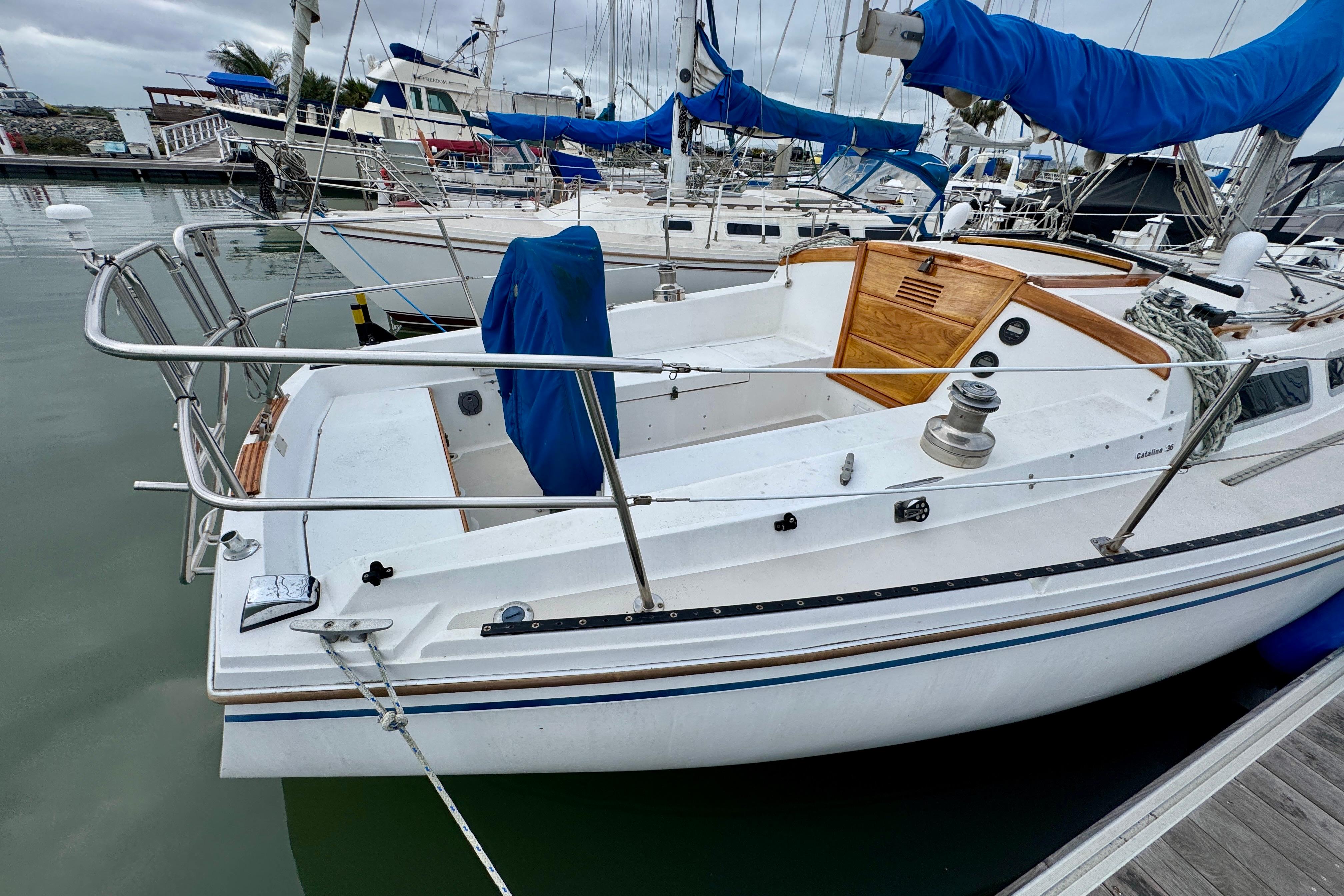 1986 Catalina 36 sailboat docked in marina, featuring spacious cockpit and classic design.