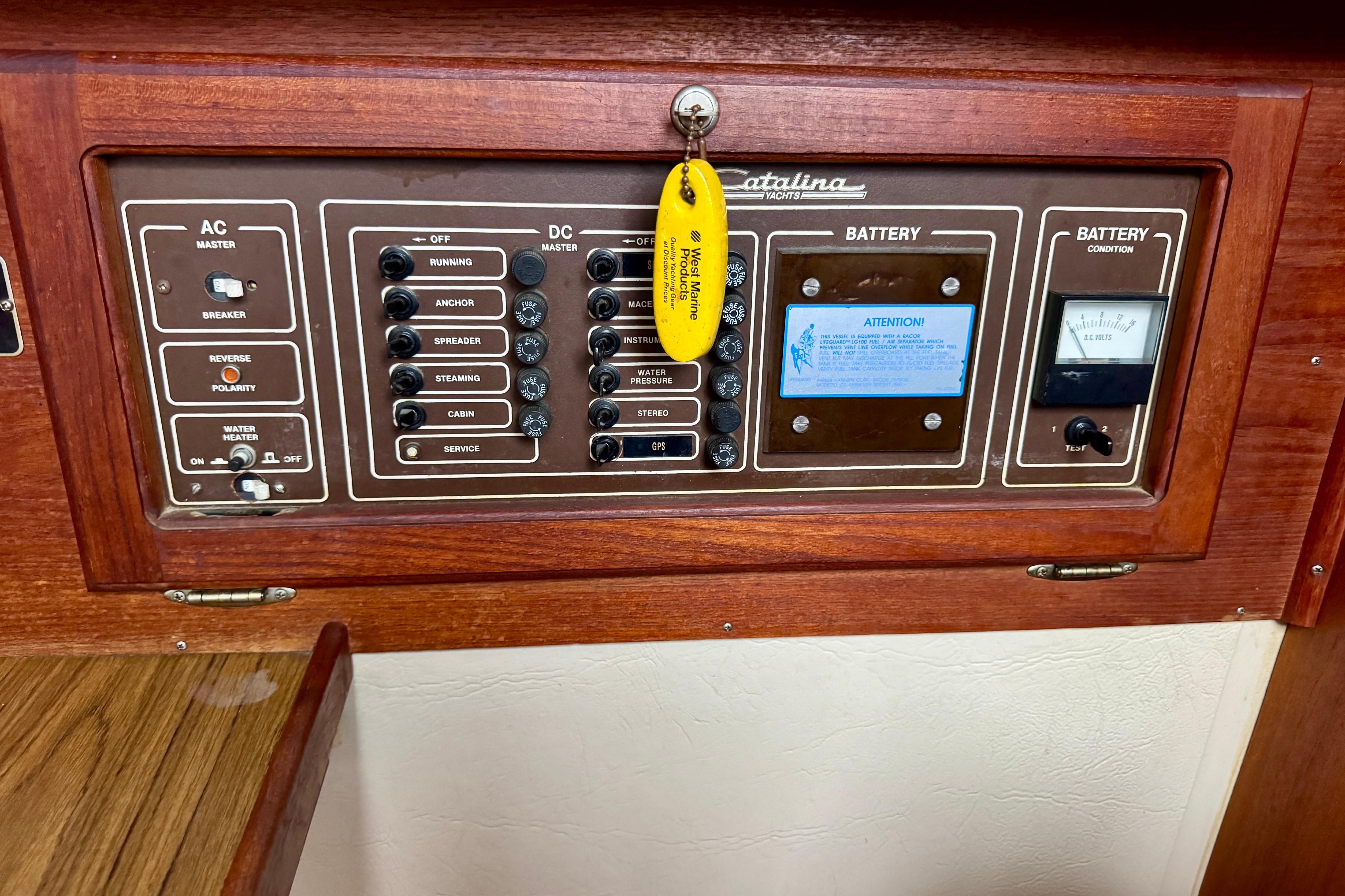 Electrical control panel of a 1986 Catalina 36 yacht with AC and DC switches.