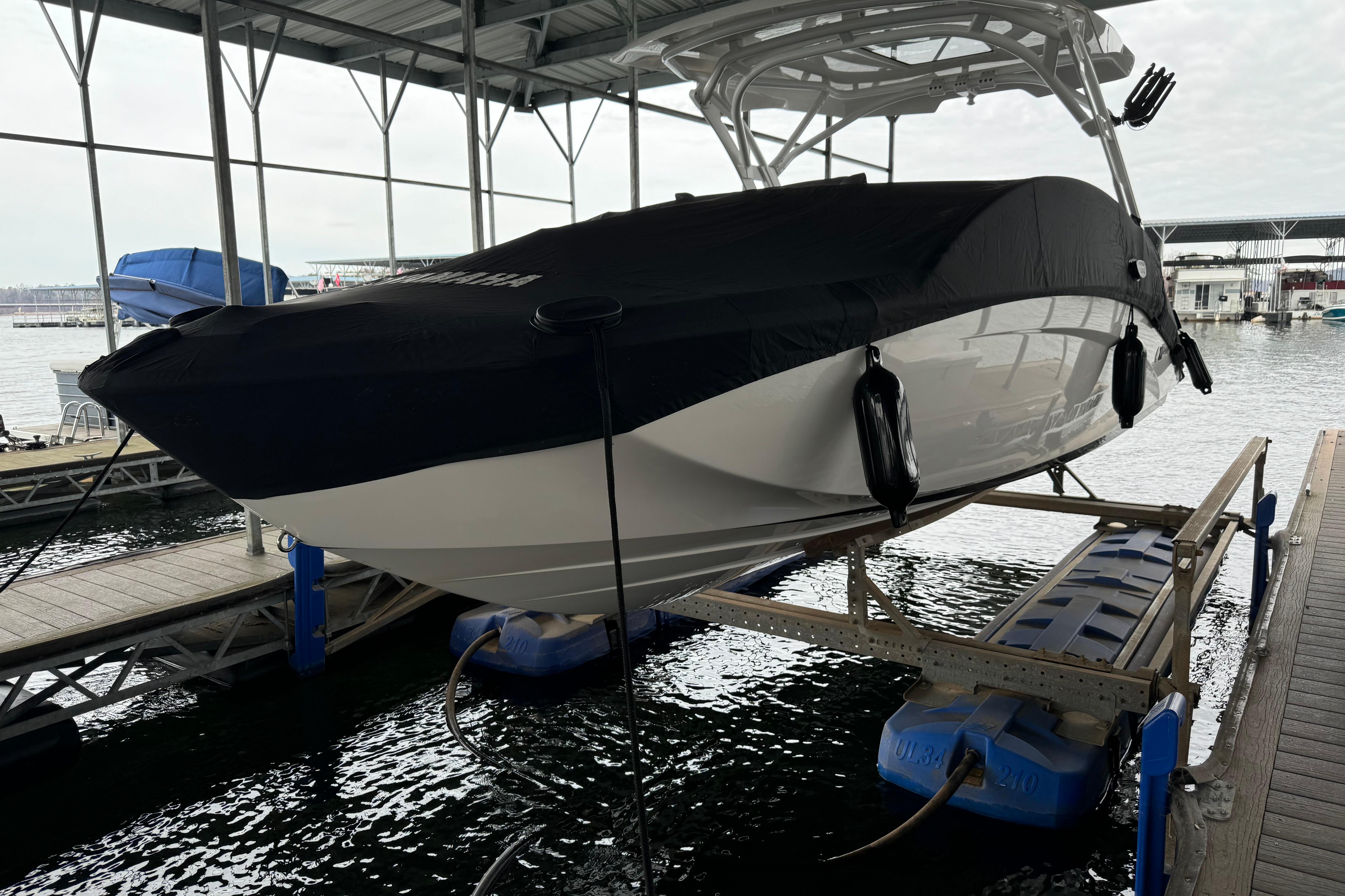 2024 Yamaha Boats 275SD docked, covered, and elevated at a marina.