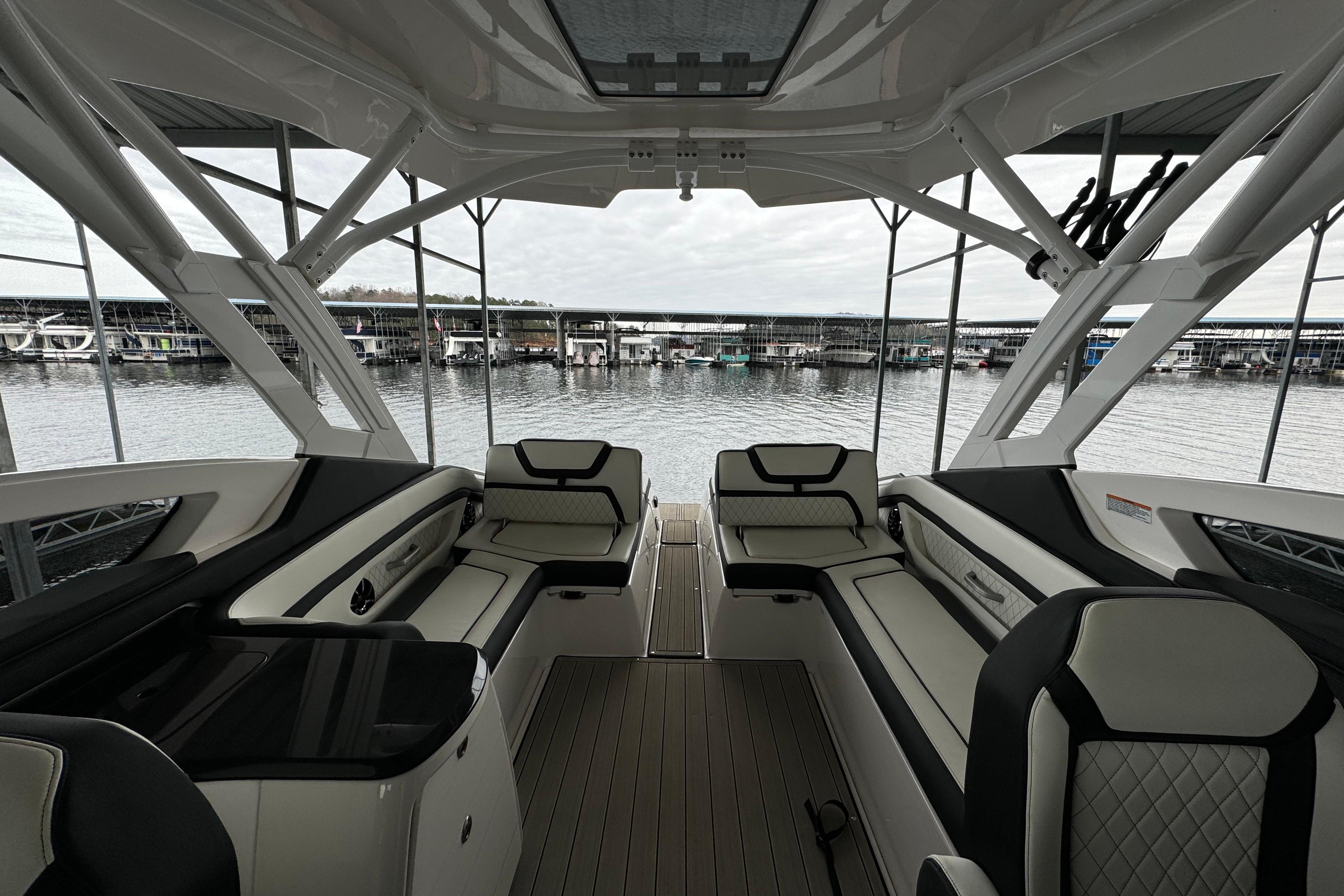 2024 Yamaha Boats 275SD interior with luxurious seating and waterfront view.