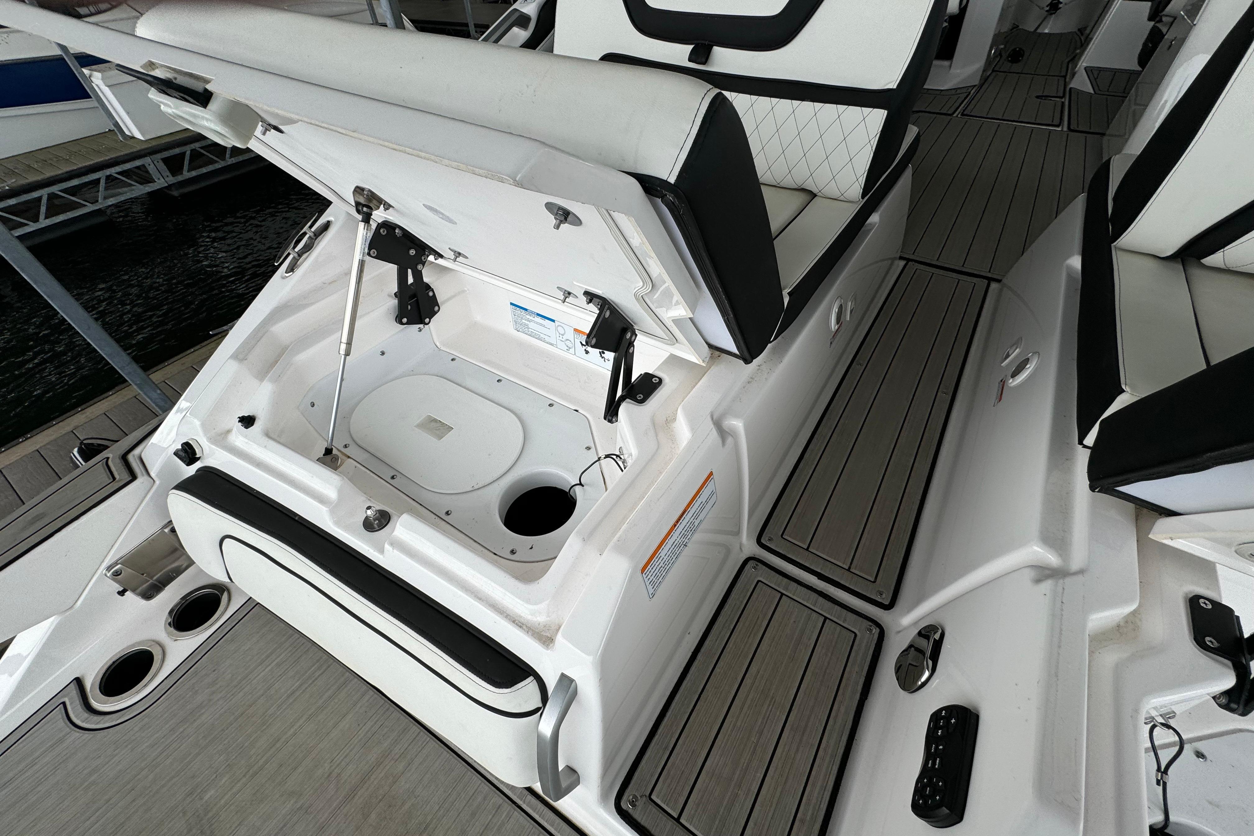 2024 Yamaha Boats 275SD interior with open storage compartment and seating.