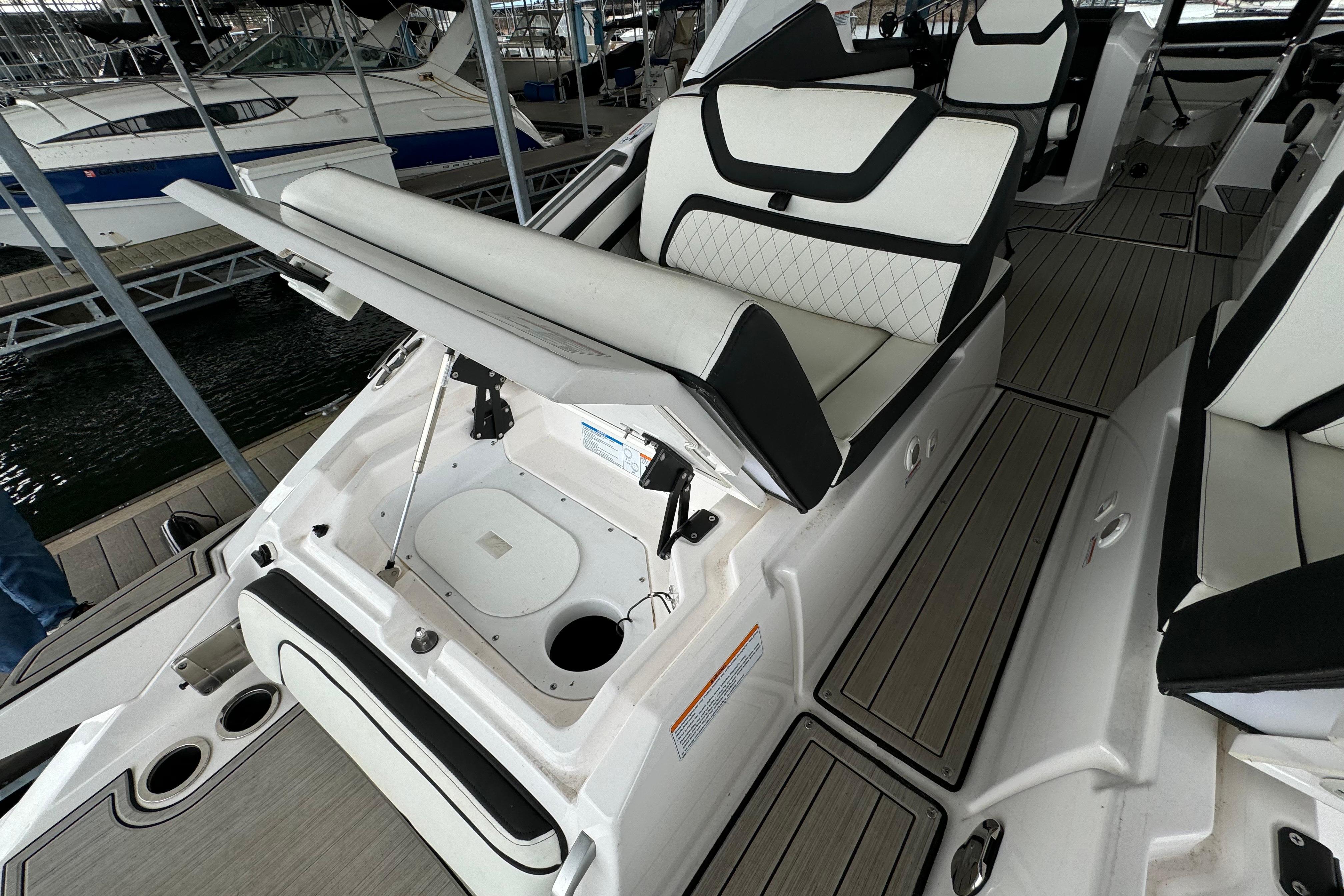 2024 Yamaha Boats 275SD interior with open storage compartment and sleek seating design.