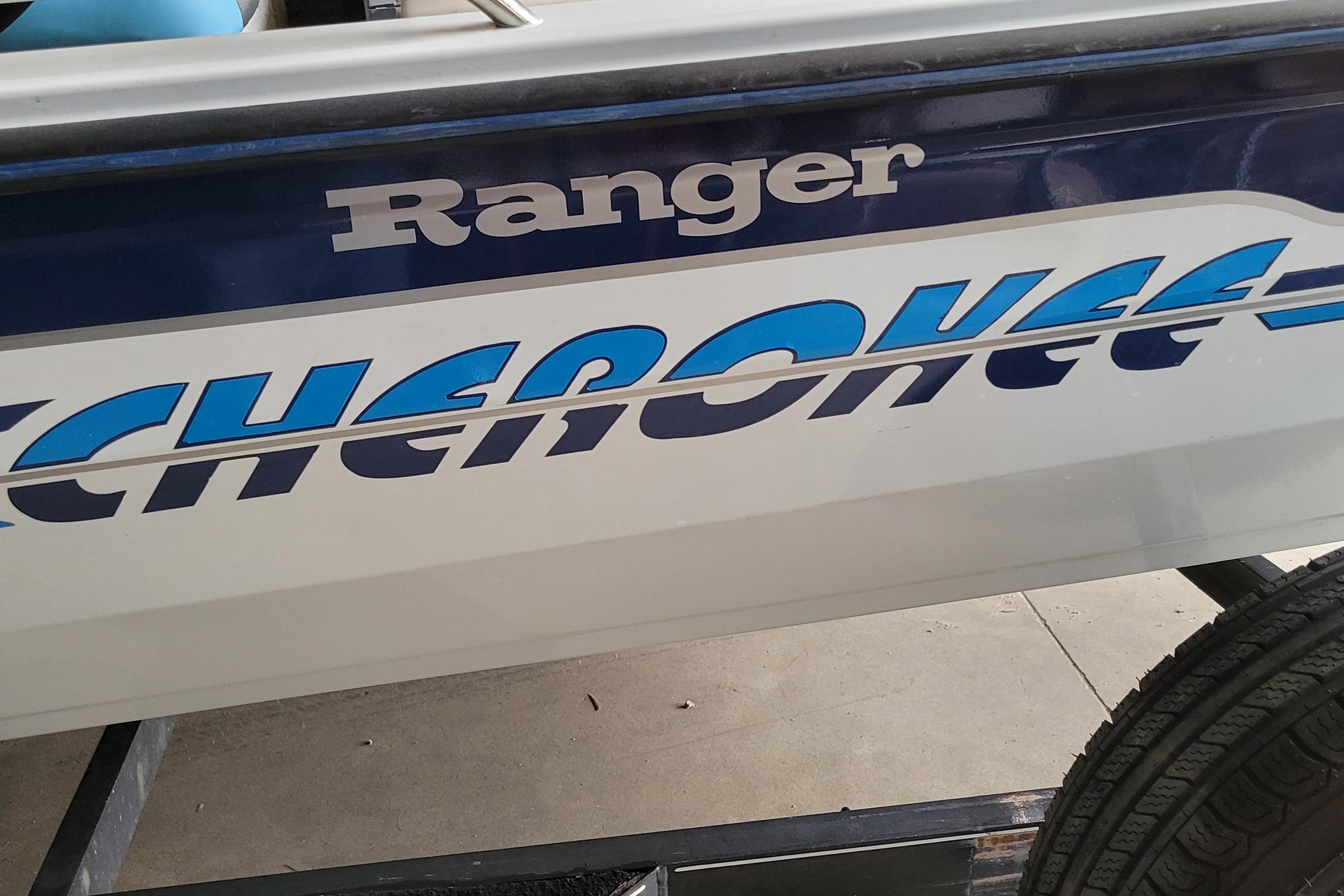 1999 Ranger 107 Cherokee boat with bold blue lettering on the side.