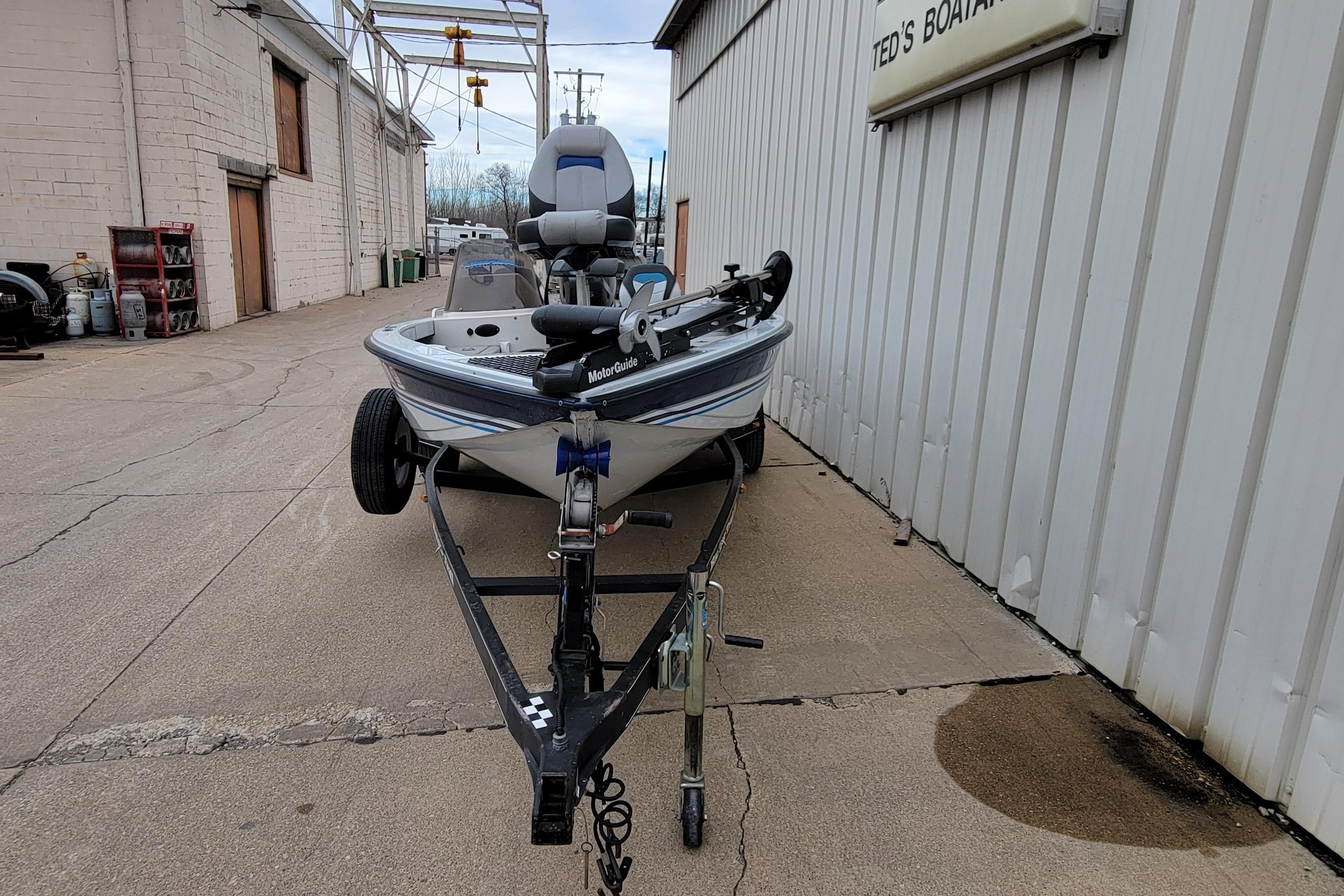 1999 Ranger 107 Cherokee boat on trailer outside Ted's Boating shop.