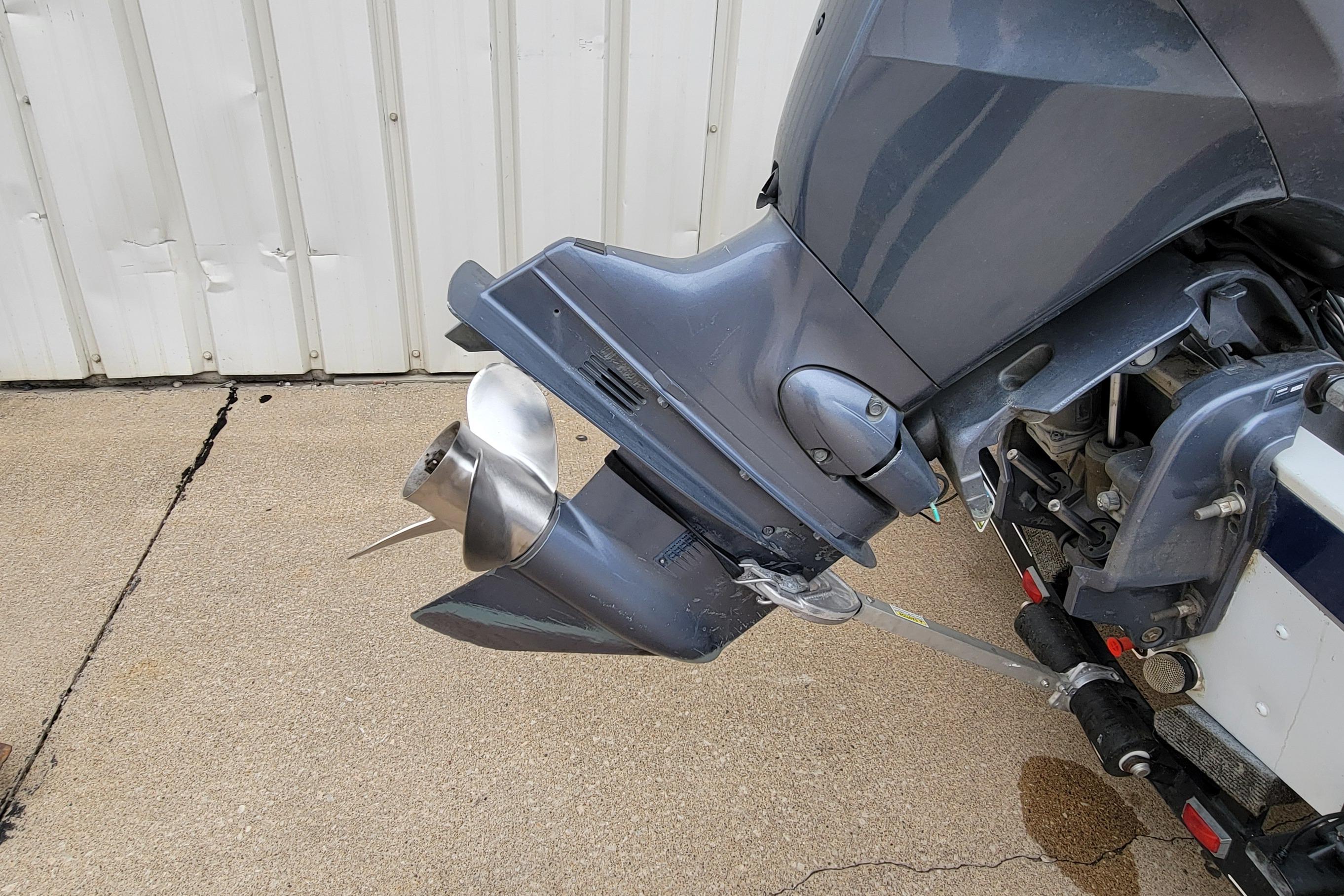 1999 Ranger 107 Cherokee boat motor with propeller on concrete surface.