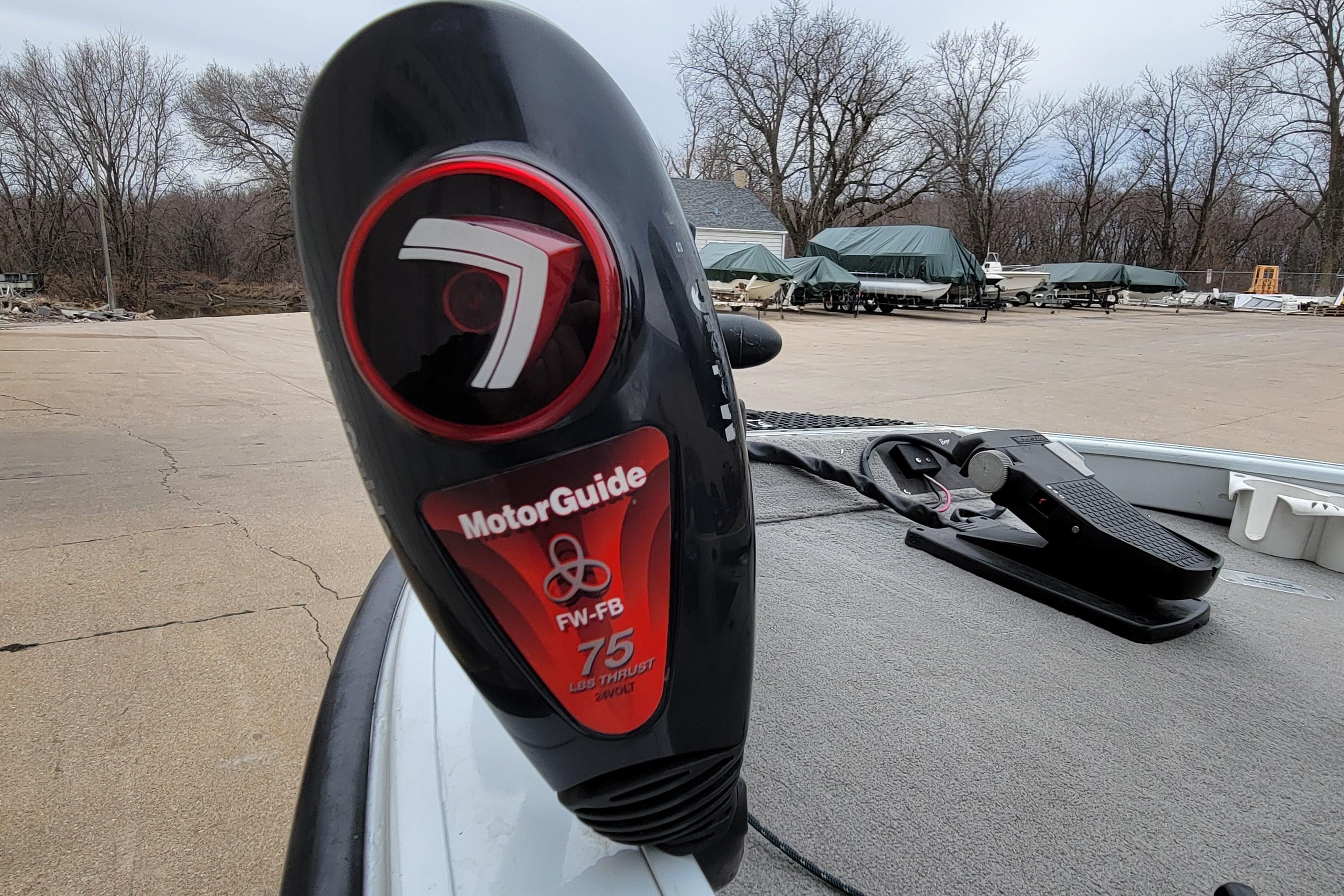 MotorGuide trolling motor on 1999 Ranger 107 Cherokee boat, parked with covered boats in background.