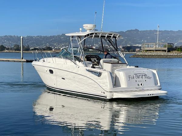 2005 Sea Ray Amberjack 290 boat on calm water, with scenic background.