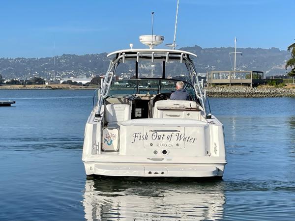 2005 Sea Ray Amberjack 290 boat on calm water, rear view, "Fish Out of Water" name visible.