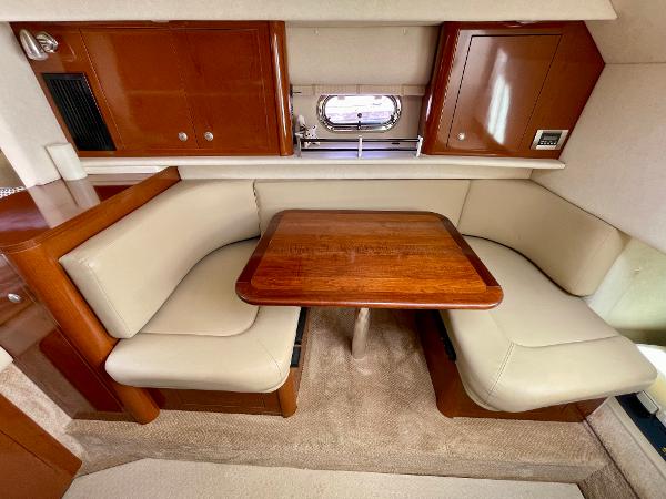 2005 Sea Ray Amberjack 290 interior with beige seating and wooden table.