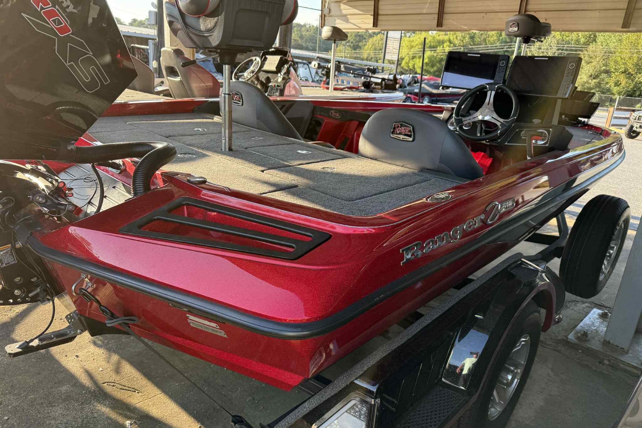 2024 Ranger Z518 boat in vibrant red, featuring a sleek design and modern dashboard.