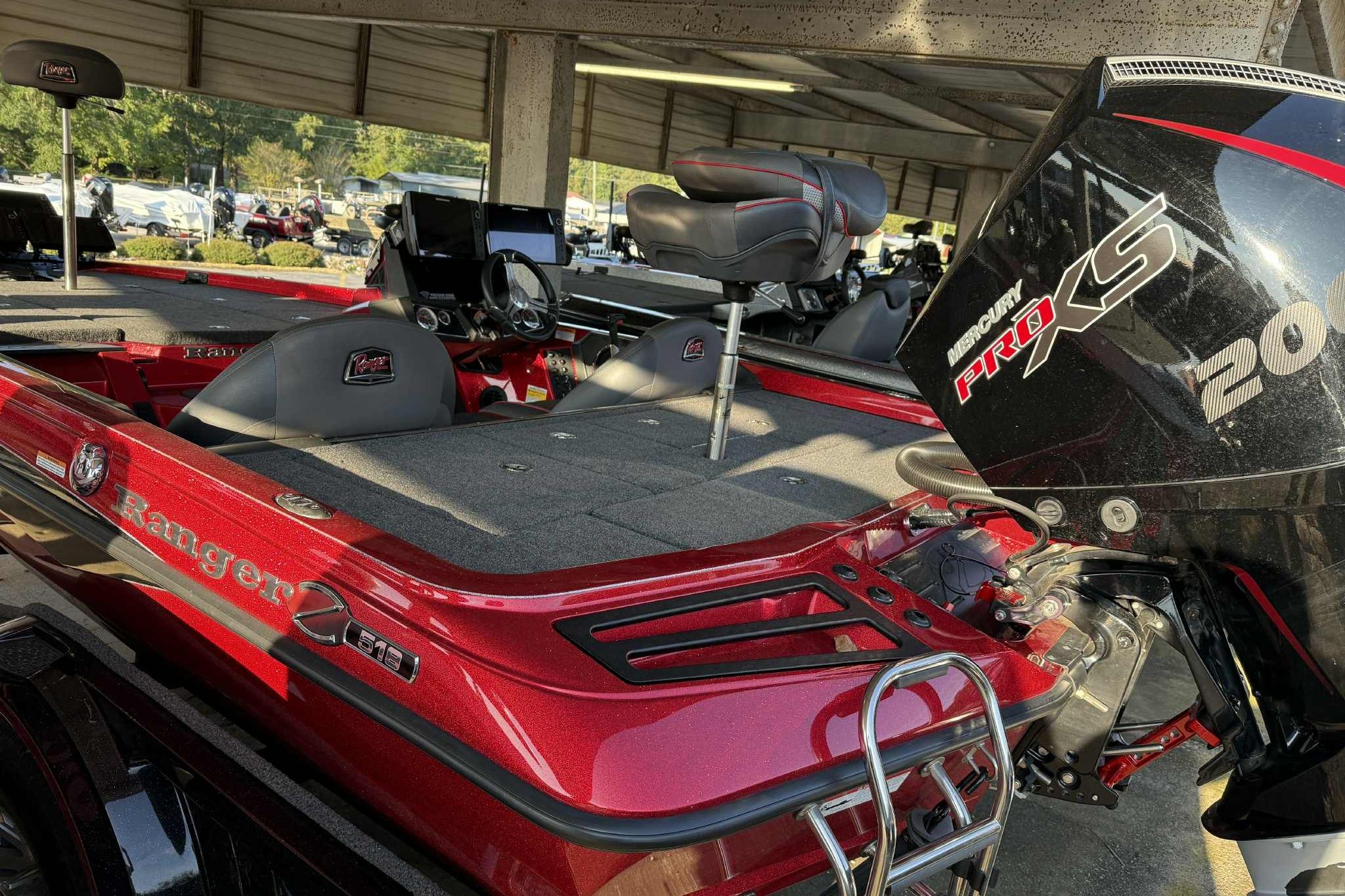 2024 Ranger Z518 boat with Mercury Pro XS engine, red finish, under covered area.