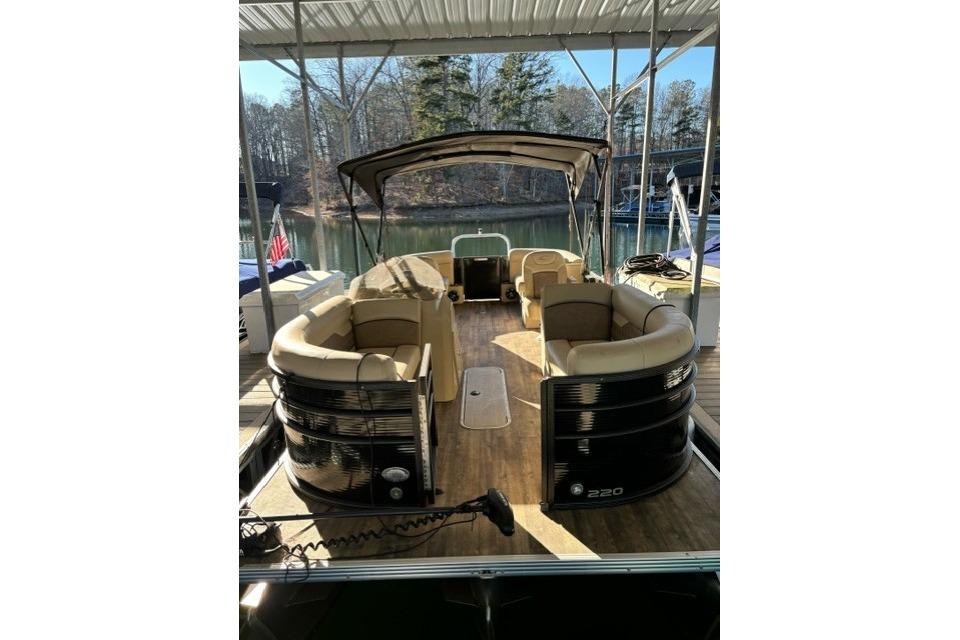 2019 Crest 220 CREST II pontoon boat docked under a canopy.