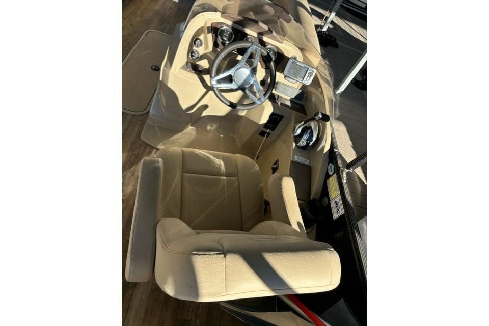 2019 Crest 220 CREST II boat interior with steering wheel and beige seating.