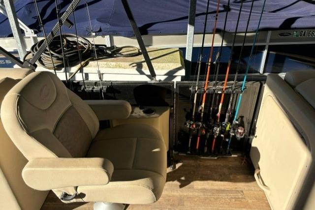 2019 Crest 220 CREST II boat interior with fishing rods and captain's chair.
