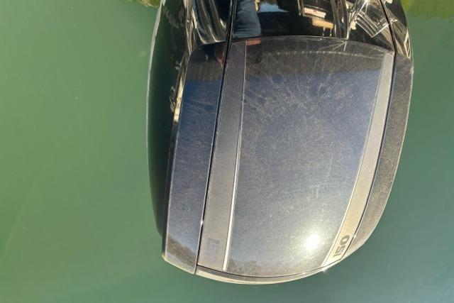 Outboard motor on a 2019 Crest 220 CREST II boat, reflecting sunlight on water.