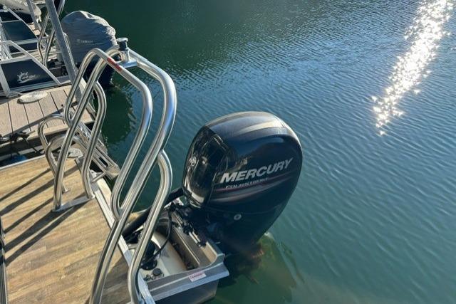2019 Crest 220 CREST II boat with Mercury outboard motor docked on calm water.