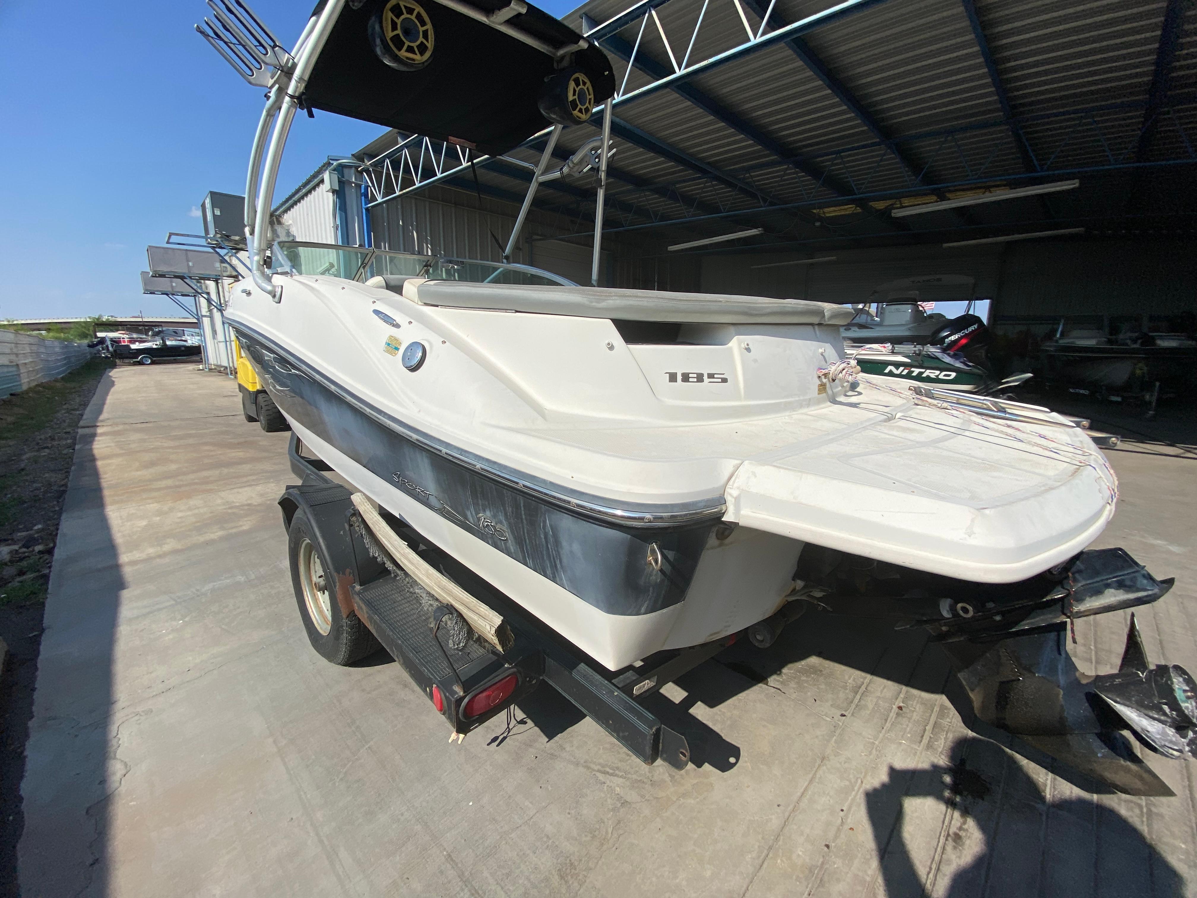 2008 Sea Ray 185 Sport boat on trailer in a covered storage area.
