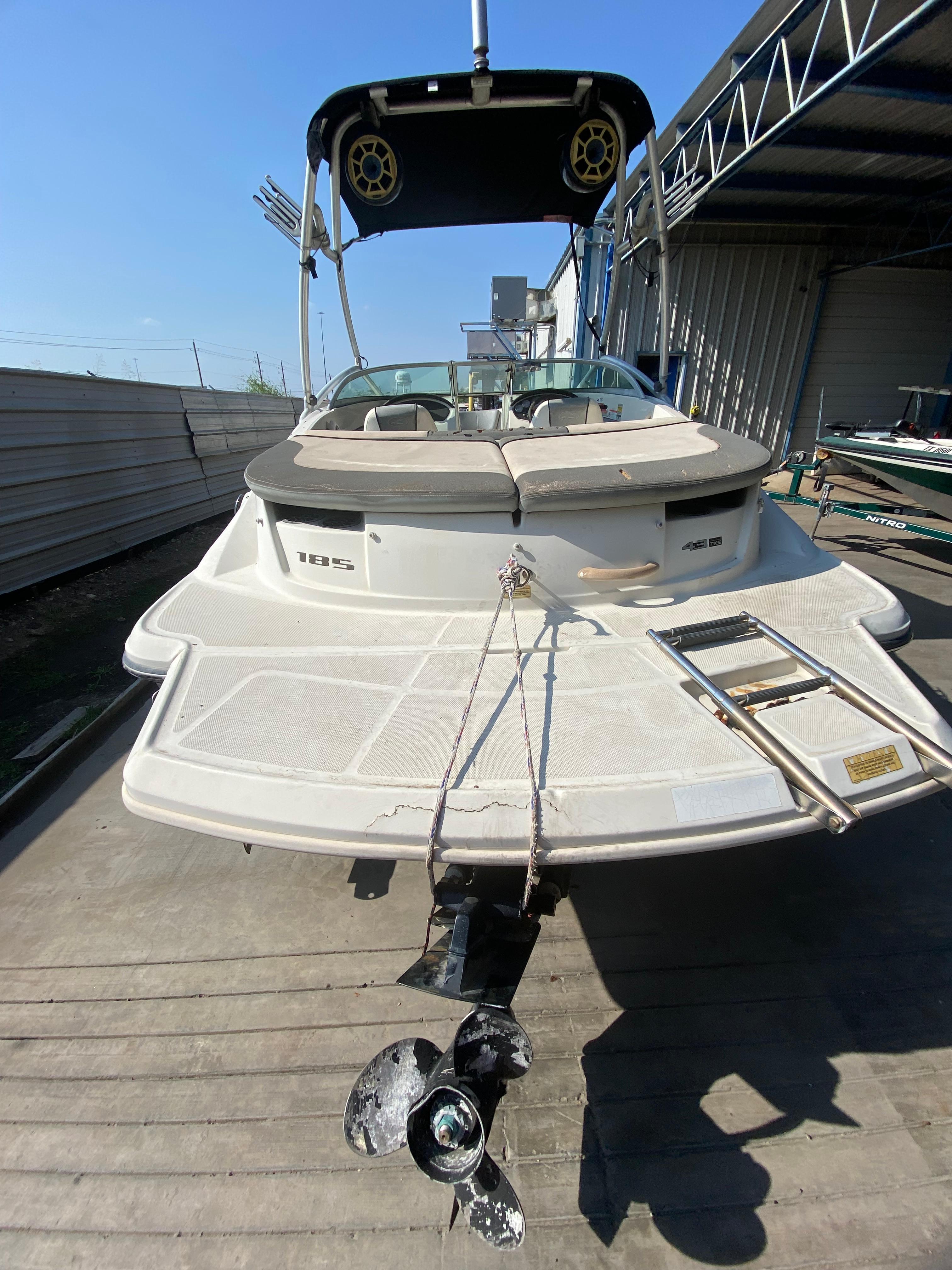 2008 Sea Ray 185 Sport boat with swim platform and ladder, docked in a marina.