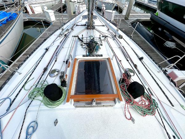 1980 Davidson 44 sailboat deck with ropes and hatch, docked at marina.