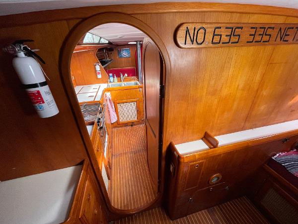 Interior of 1980 Davidson 44 yacht with wooden finish and compact kitchen area.