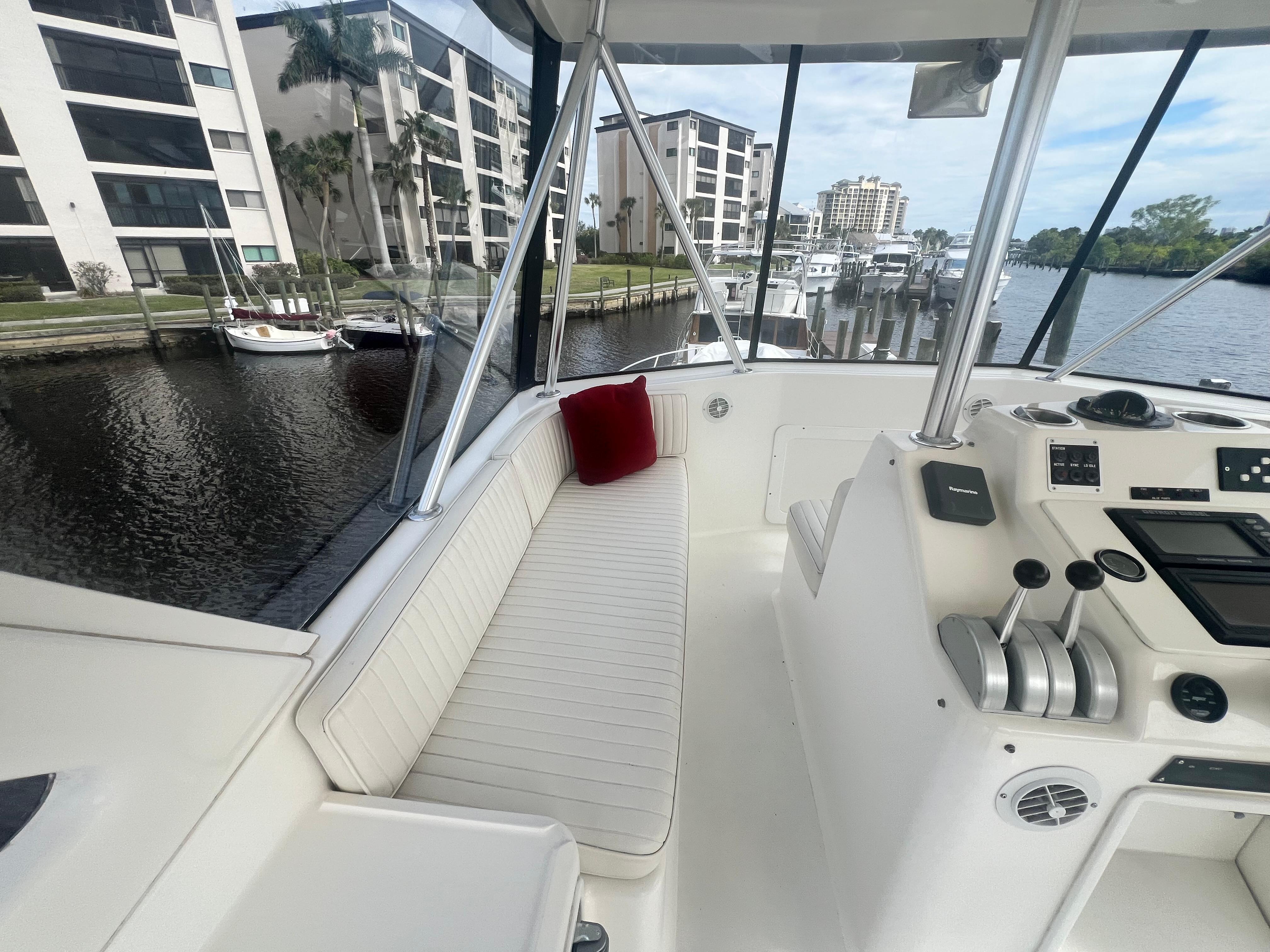 Ocean Yachts-48 Super Sport 1996-Fender Bender FL-US-1996 Ocean Yachts 48 Super Sport interior with helm, white seating, and marina view.-9657986 | Thumbnail