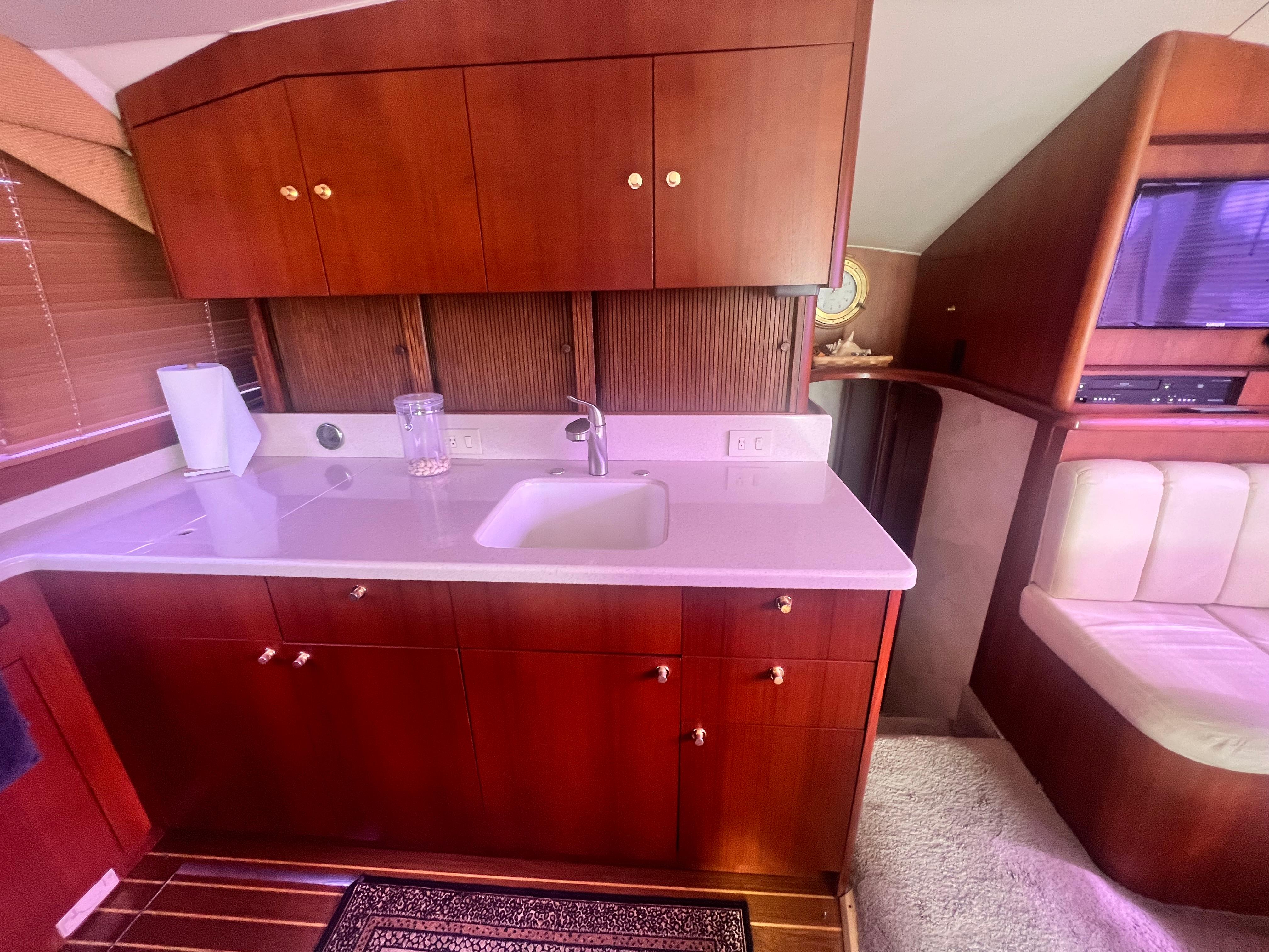Ocean Yachts-48 Super Sport 1996-Fender Bender FL-US-1996 Ocean Yachts 48 Super Sport interior with wooden cabinetry and compact kitchen area.-9657986 | Thumbnail