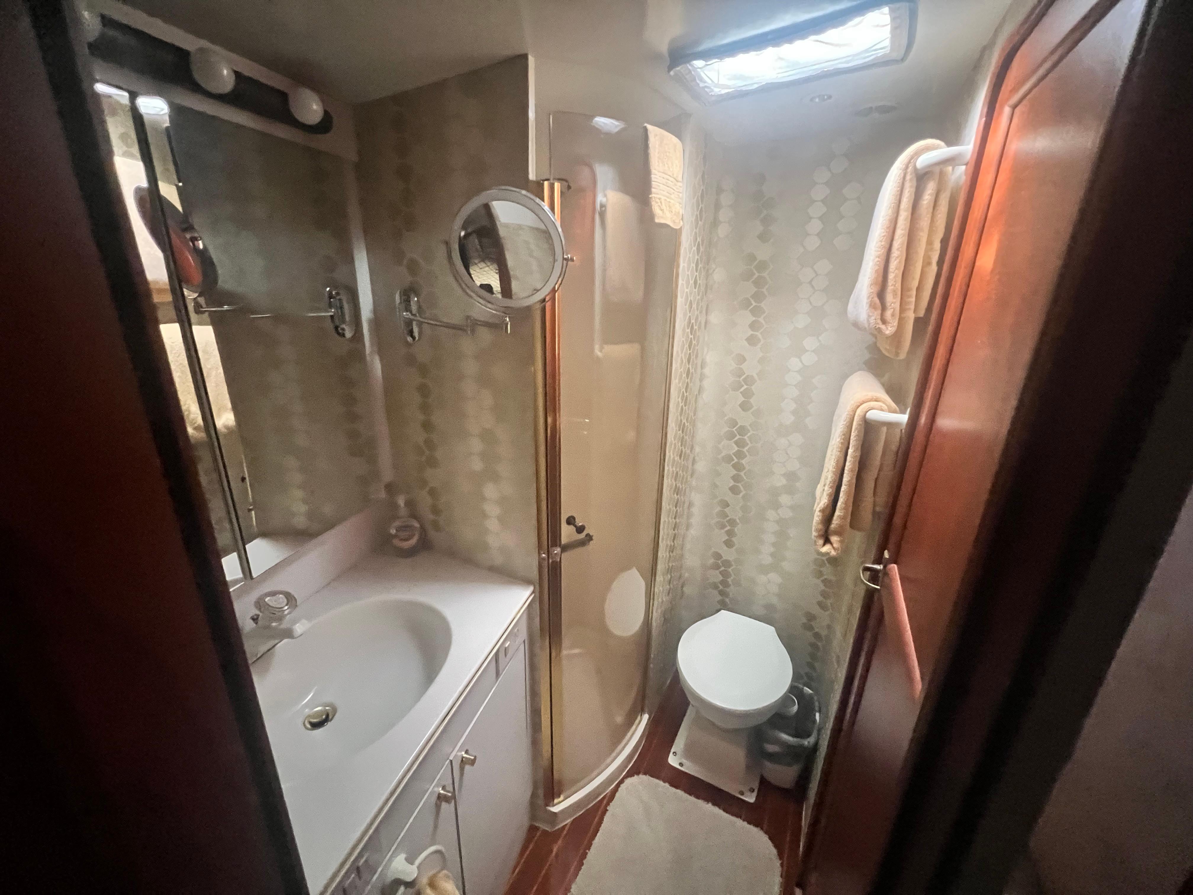 Ocean Yachts-48 Super Sport 1996-Fender Bender FL-US-Bathroom interior of 1996 Ocean Yachts 48 Super Sport, featuring shower, sink, and toilet.-9657986 | Thumbnail