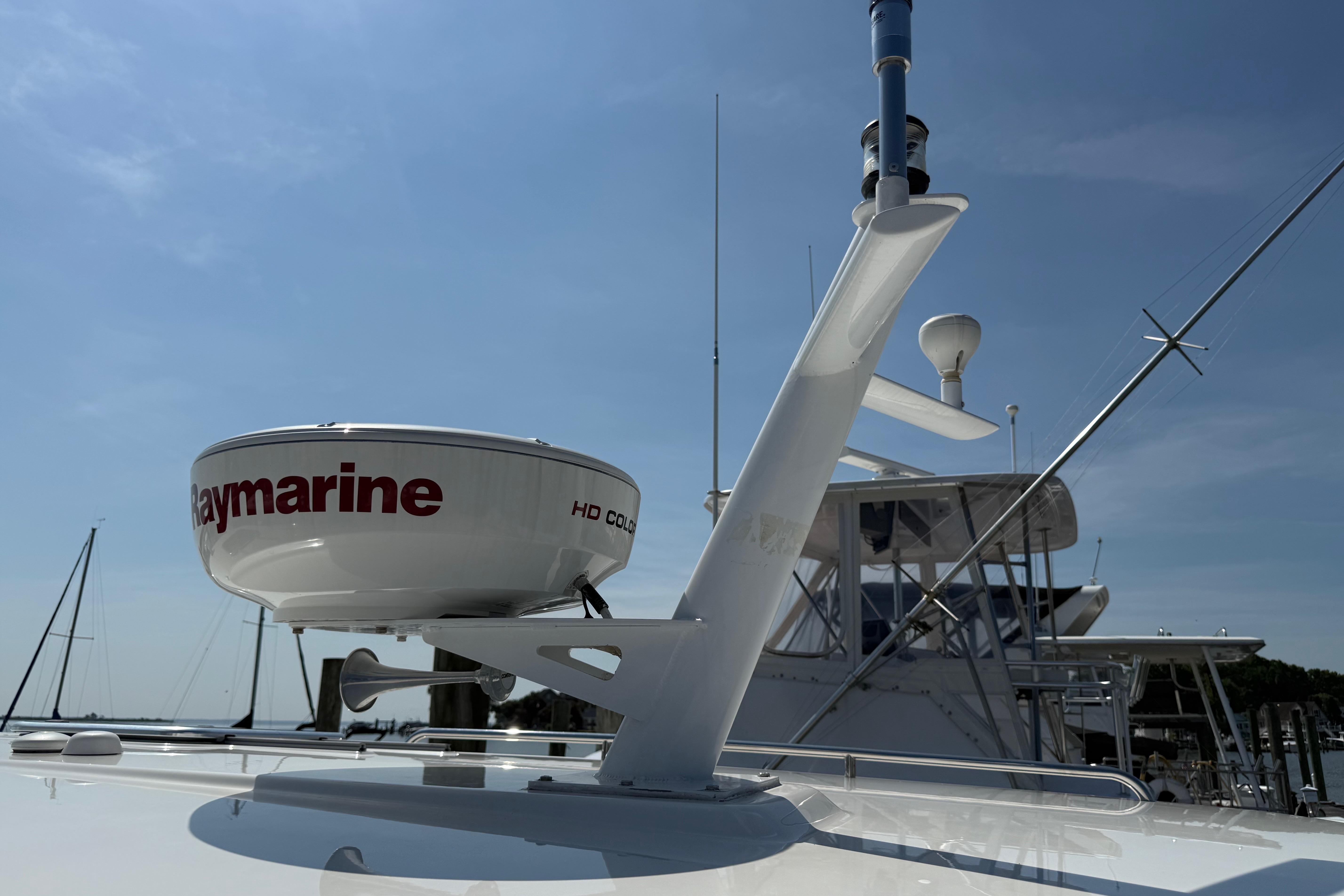 Radar equipment on a 2013 Back Cove 34 boat under a clear blue sky.