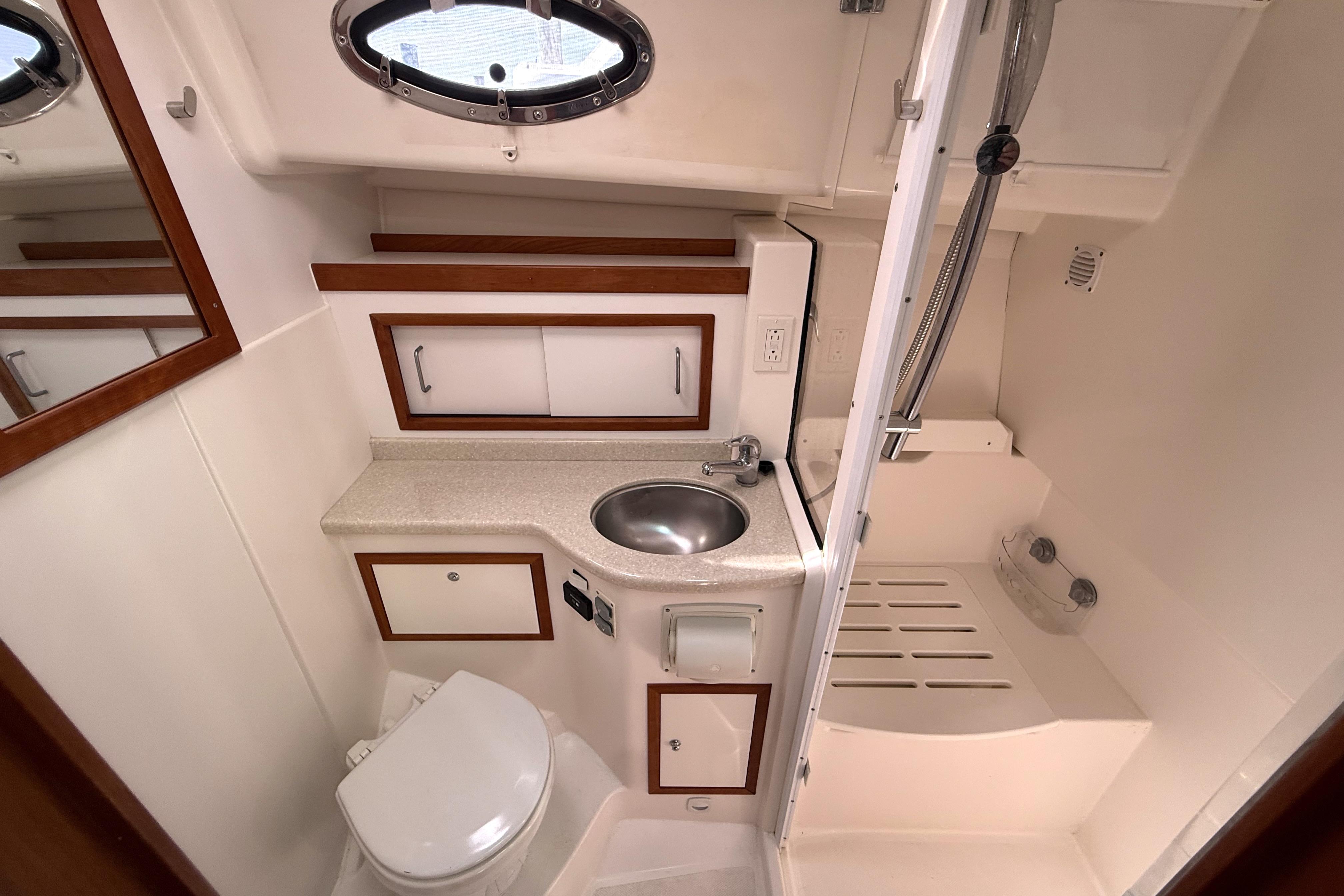 2013 Back Cove 34 yacht bathroom with sink, toilet, and shower area.