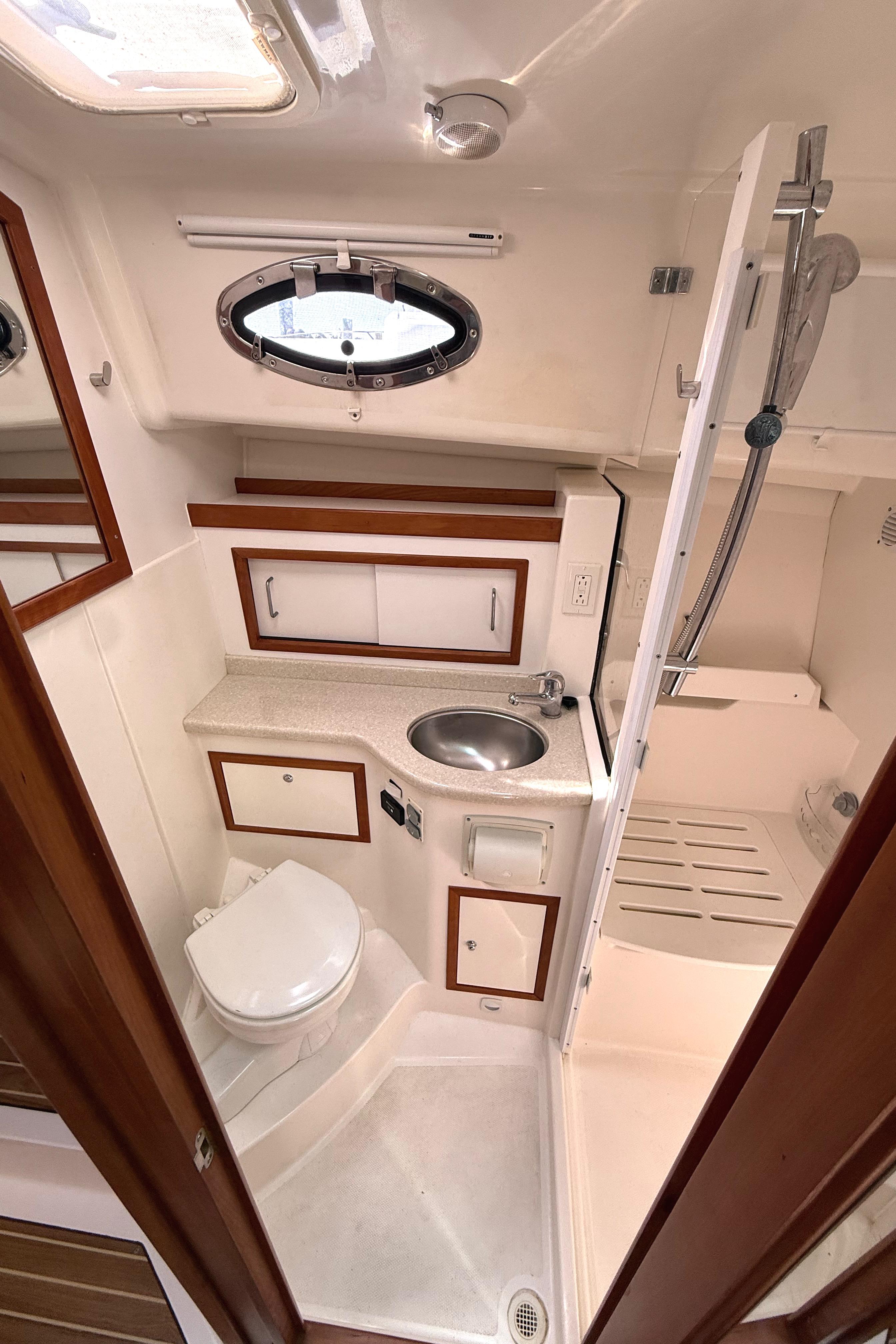 2013 Back Cove 34 yacht bathroom with sink, toilet, and shower.