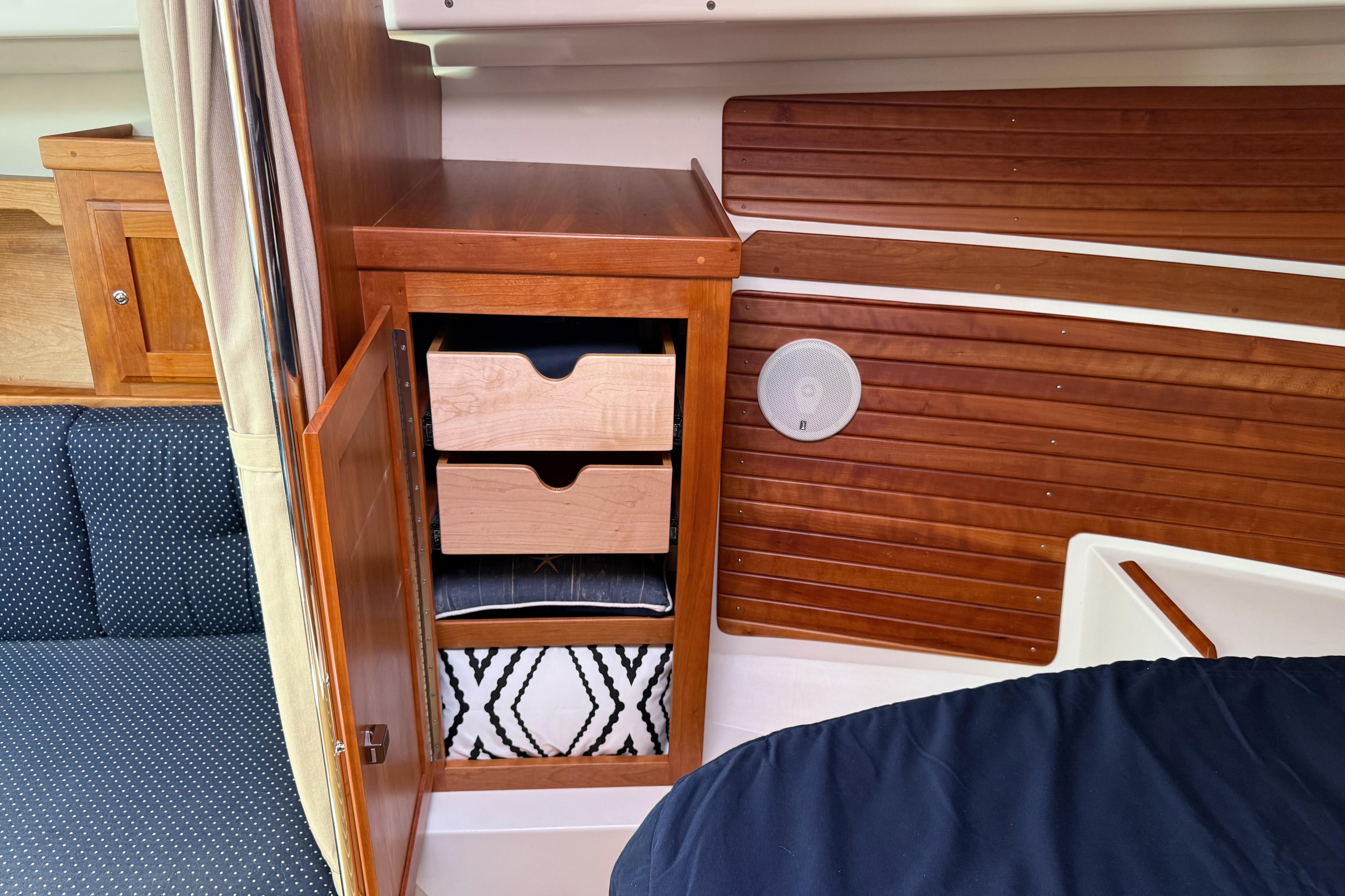 2013 Back Cove 34 interior with wooden cabinetry and storage drawers.