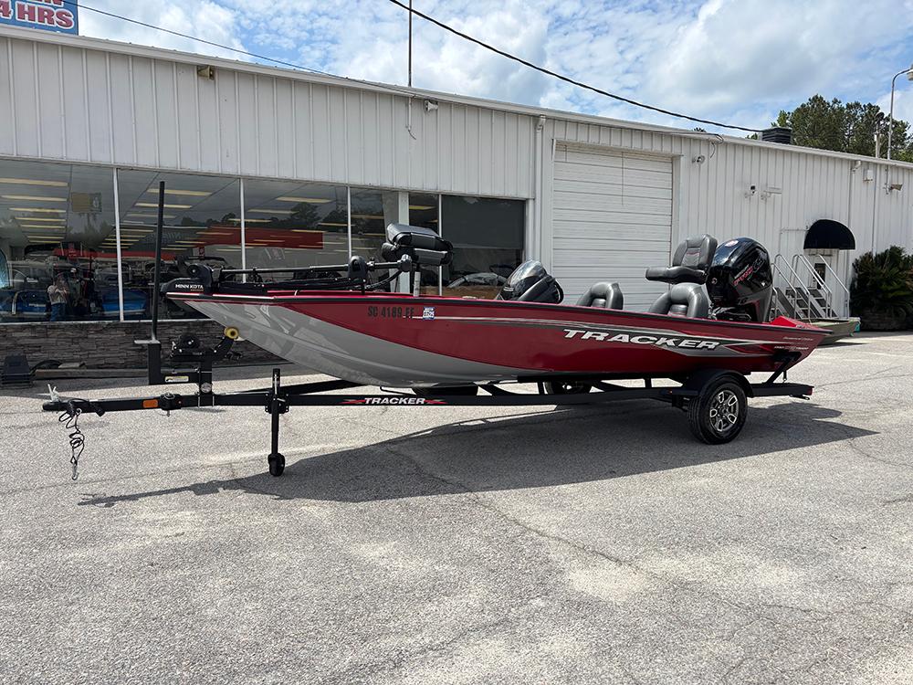 2024 Tracker Pro Team 190 TX boat on trailer, parked outside a dealership.