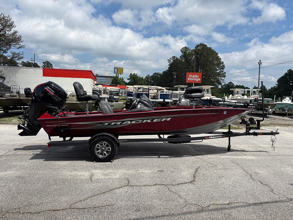 2024 Tracker Pro Team 190 TX boat on trailer, parked outdoors under cloudy sky.