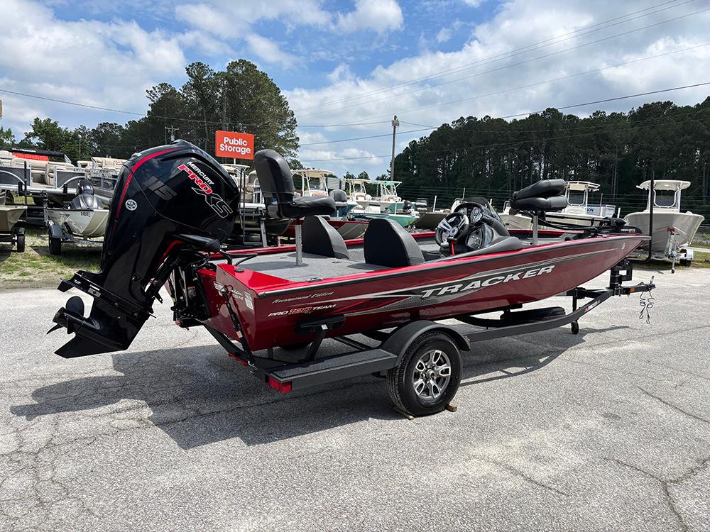 2024 Tracker Pro Team 190 TX boat on trailer, parked outdoors under cloudy sky.