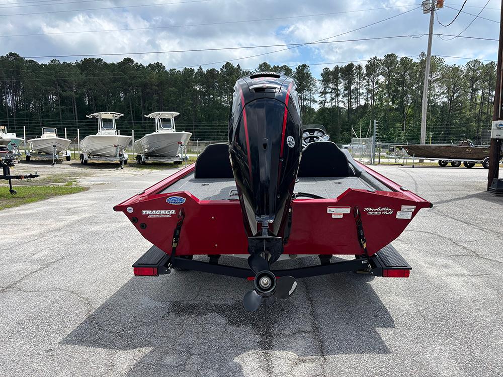 2024 Tracker Pro Team 190 TX boat, red, rear view, parked outdoors.