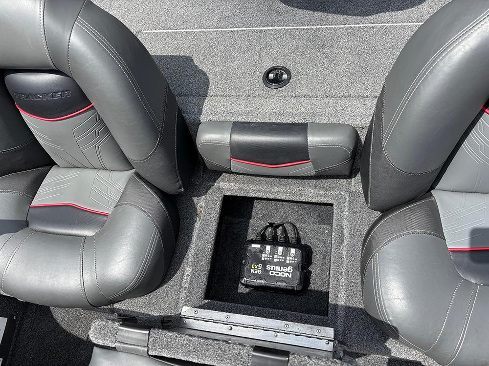 2024 Tracker Pro Team 190 TX boat interior with storage compartment and NOCO Genius charger.