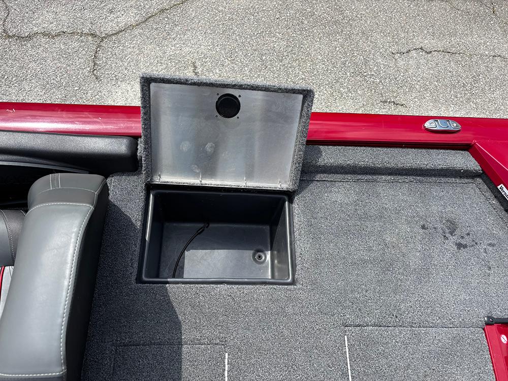 2024 Tracker Pro Team 190 TX boat storage compartment with open lid on carpeted deck.