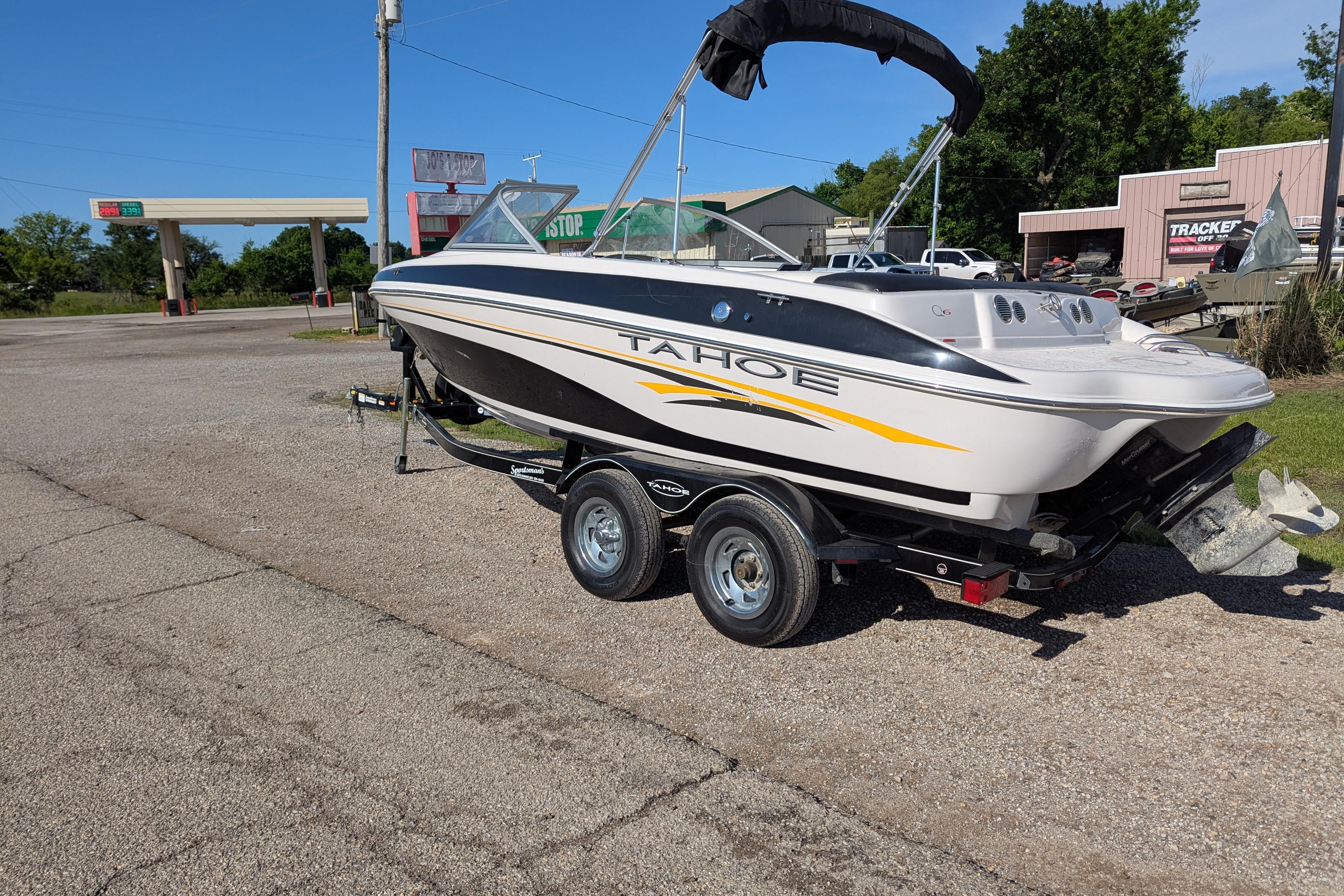 2006 Tahoe Q6 Sport boat on trailer in parking lot, sunny day.
